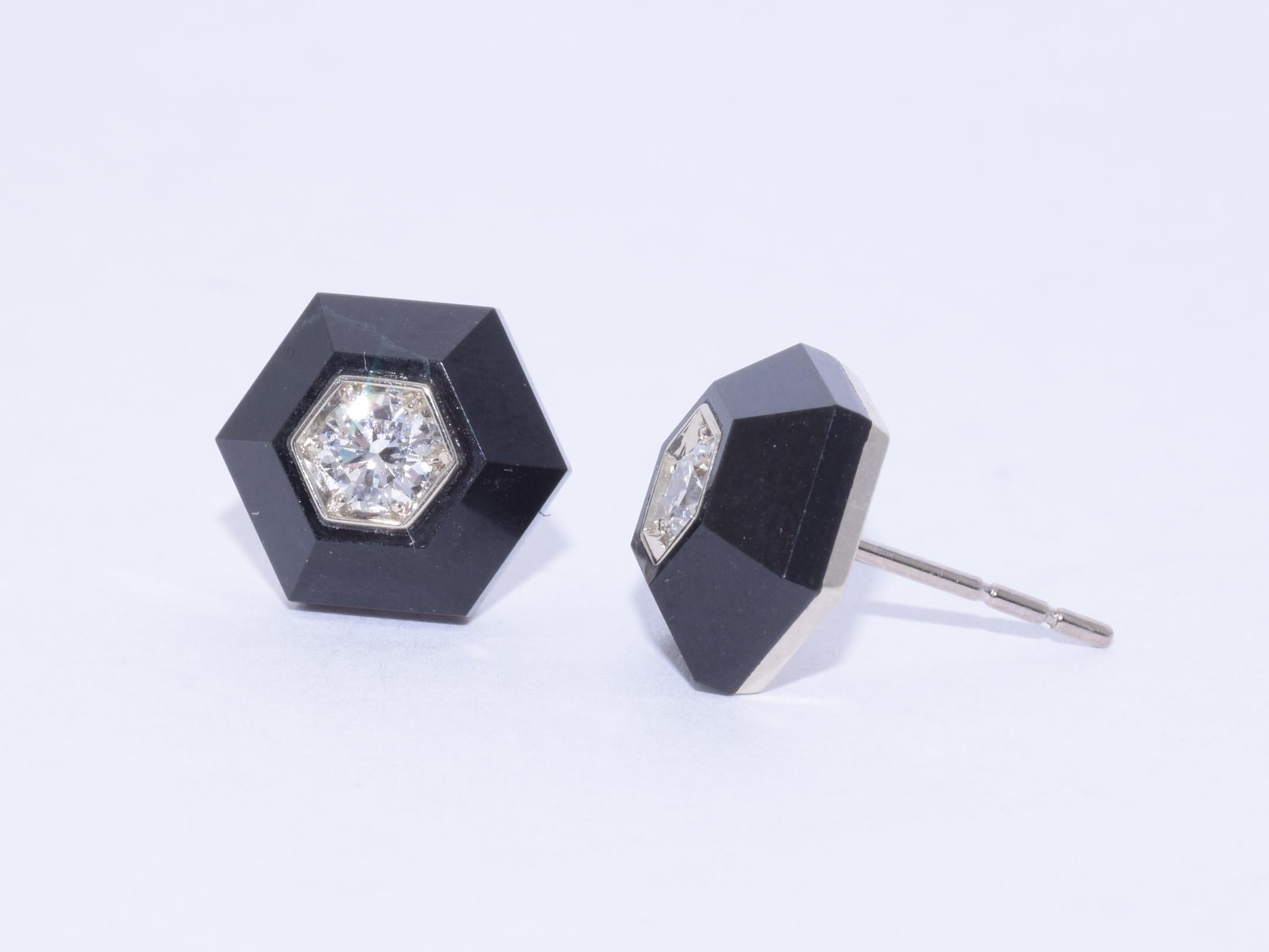 A pair of round diamonds totaling approximately 0.36 carats are inset to black jade hexagons mounted in 18 karat white gold. Signed Fred Leighton. The earrings measure approximately 11 x 9.6mm. 

Fred Leighton is renowned for extraordinary