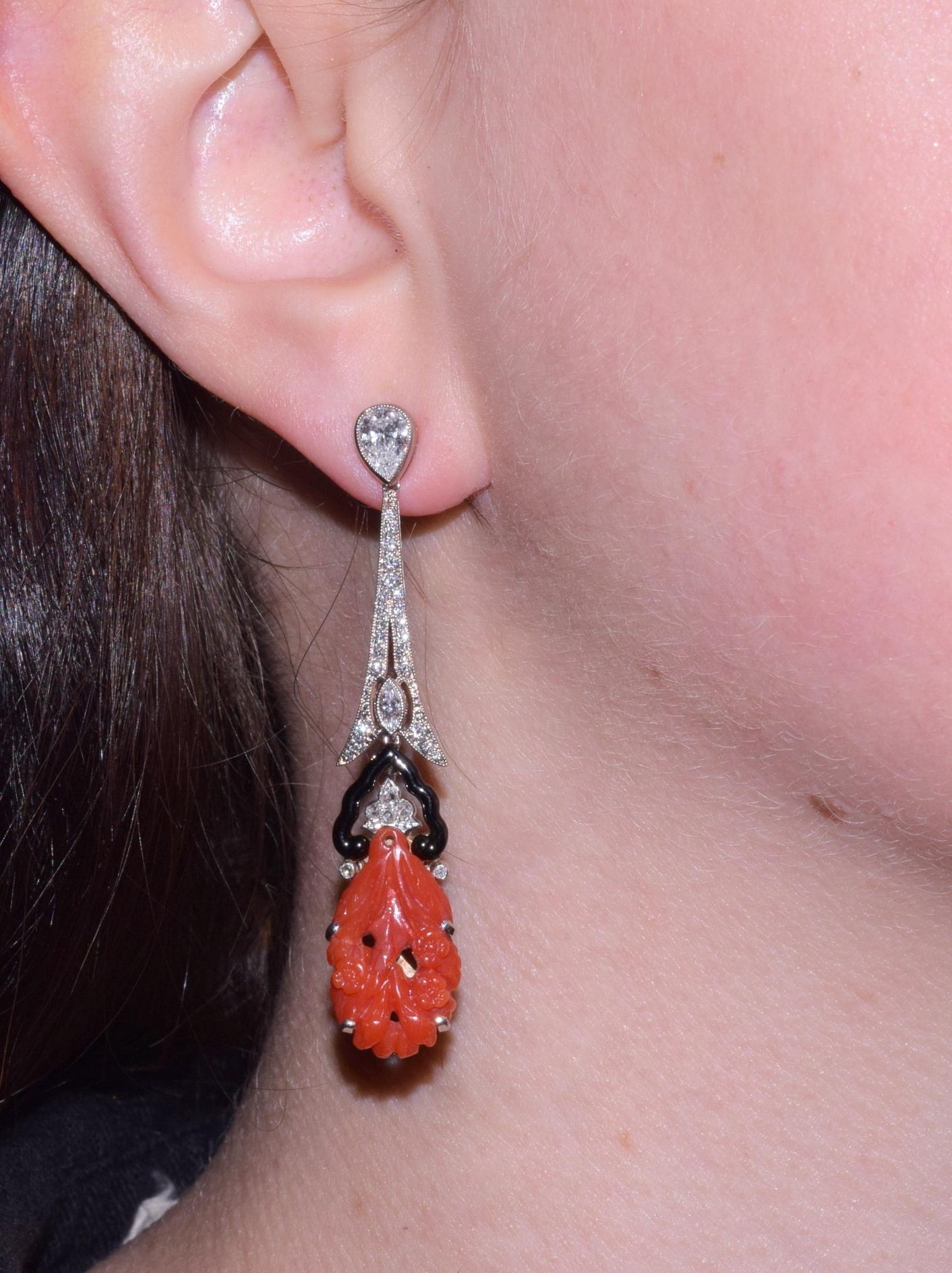 Art Deco carved coral plaques mounted with black enamel and diamonds, originally  elements of a brooch, have been reimagined by Fred Leighton as earrings suspended from decorative tops composed of pear shape, marquise and round diamonds totaling
