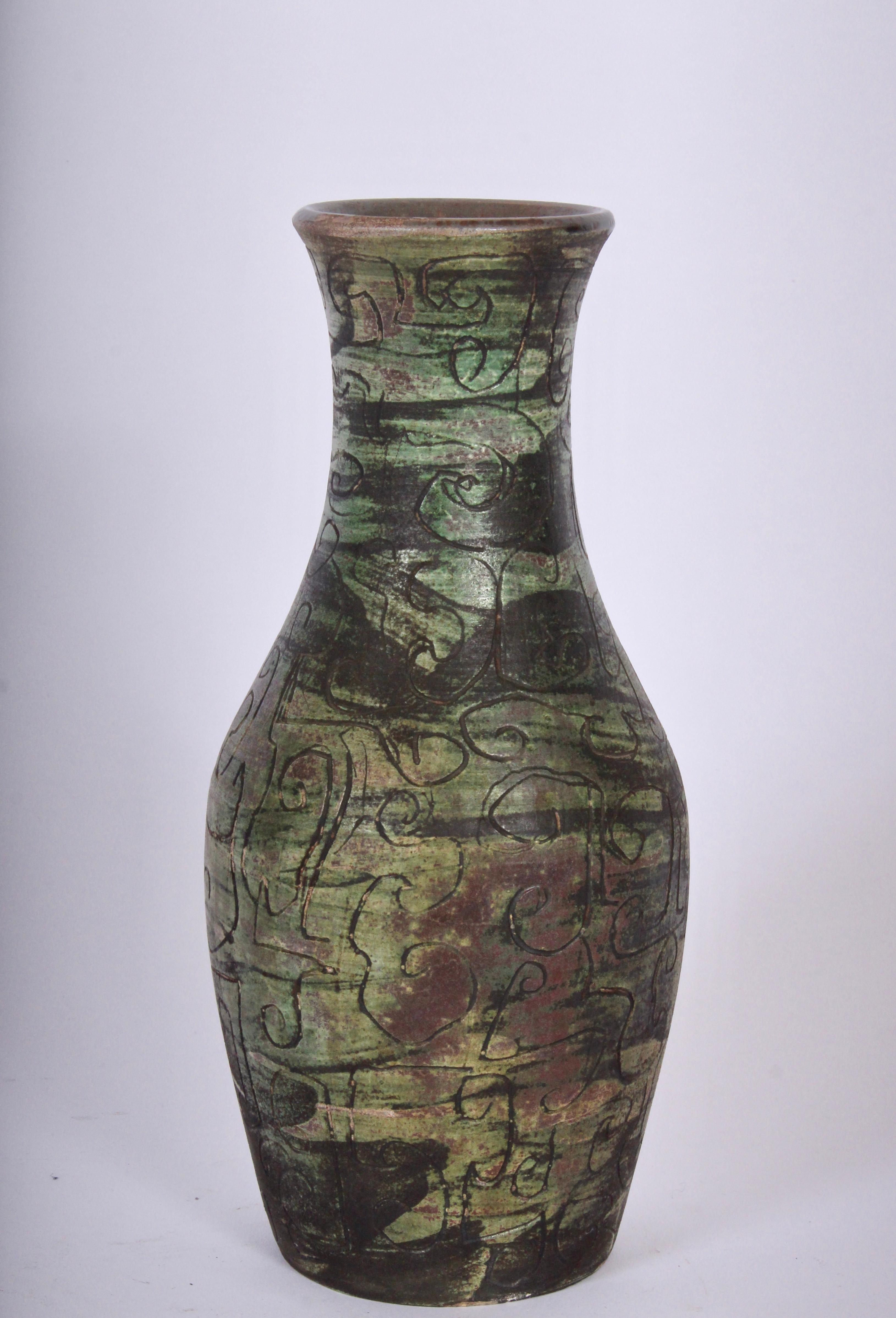Handcrafted french ceramic incised vase with lively Green toned color. Featuring hand applied sgraffito decoration in bright camouflage tonality. Greens, Taupe, Brown, Gold, Mauve, Earthen coloration. Reflective. Gloss glazed interior. 3.5D top.