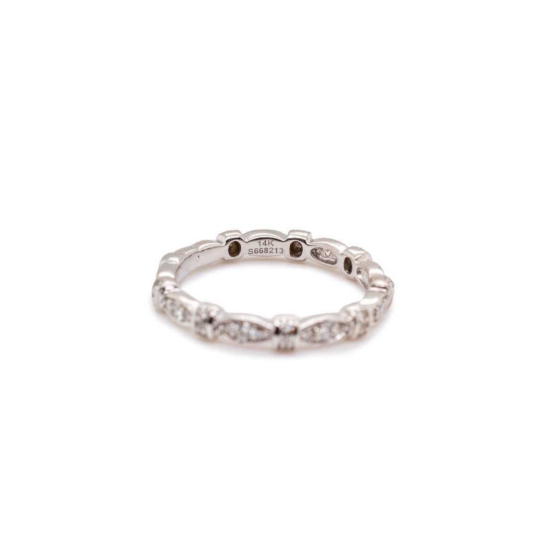 One lady's designer made polished rhodium plated 14K yellow gold, diamond anniversary, matching wedding, eternity band with a half-round shank. The band is a size 6.75 and measures approximately 2.90mm tapering to 2.20mm in width and weighs a total