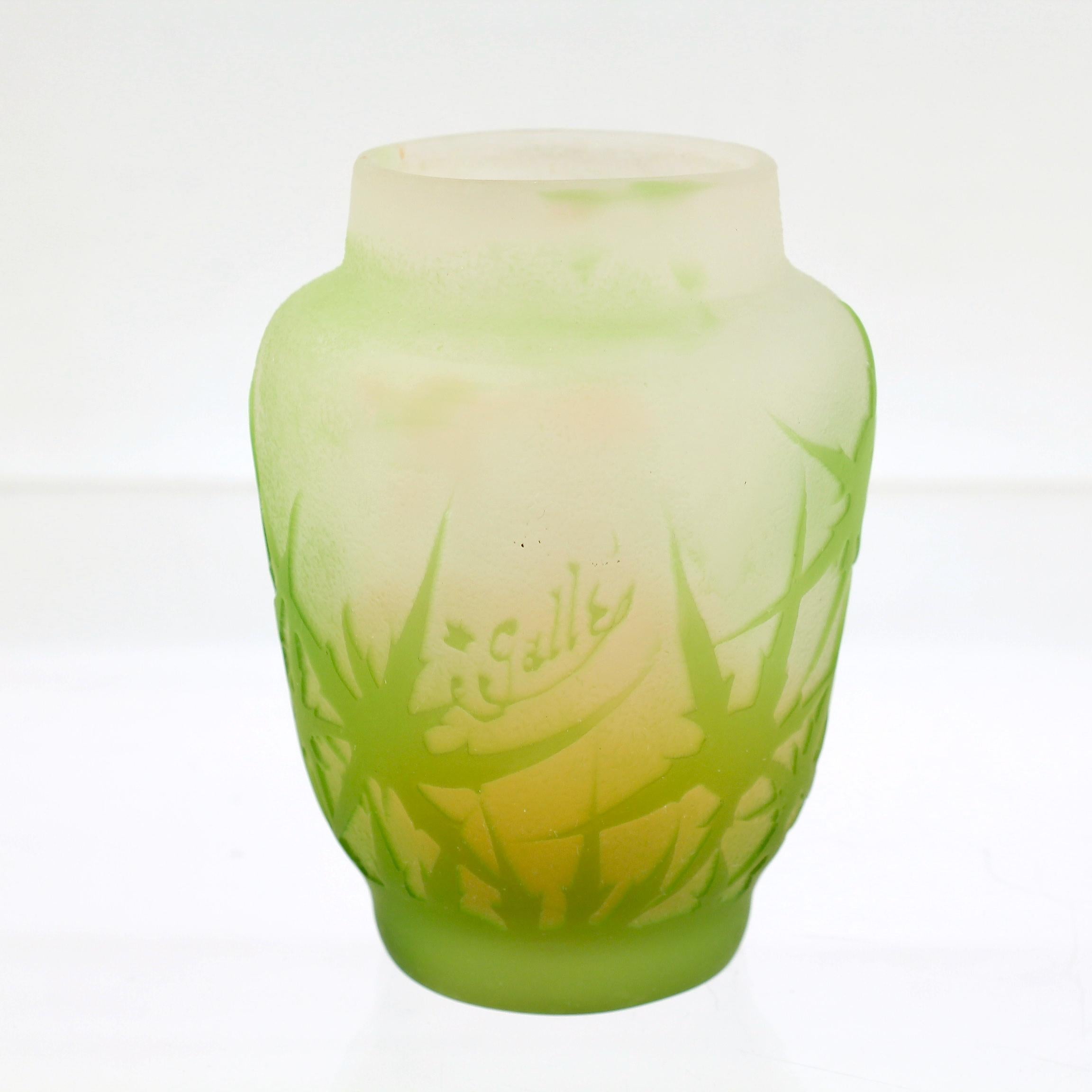 A fine signed, diminuitive Galle vase.

In an acid-cut green thistle pattern over a delicate salmon pink to clear frosted interior.

Signed in the decoration 'Galle'. Bearing a wax pencil mark to the base '35'.

Simply a wonderful cabinet