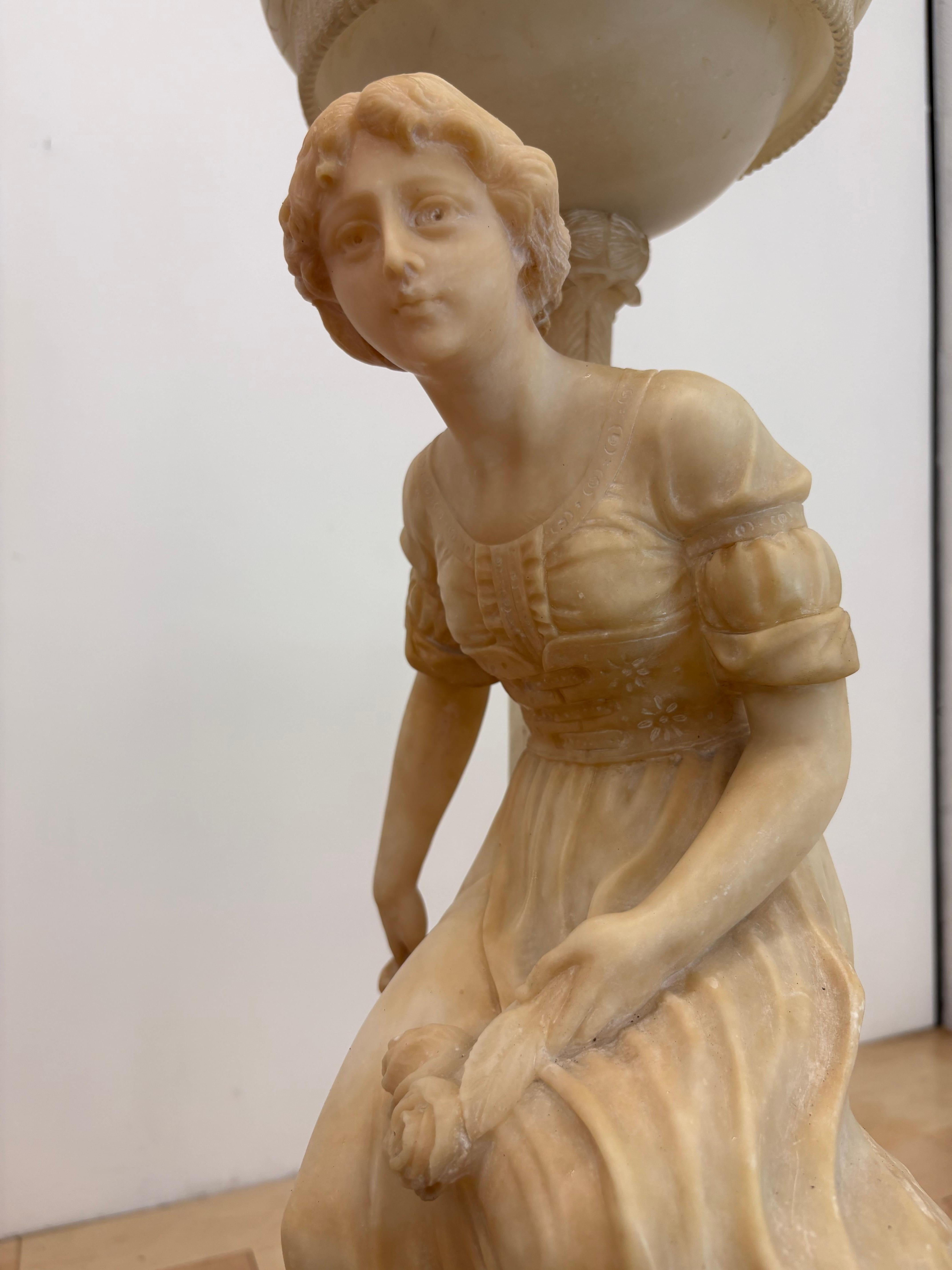 Rare antique Italian alabaster figural lamp signed by sculptor Gaspar Mascagni, circa early 20th century. This hand-carved neoclassical sculpture lamp features a seated maiden in flowing robes with intricate detail, softly illuminated by a domed
