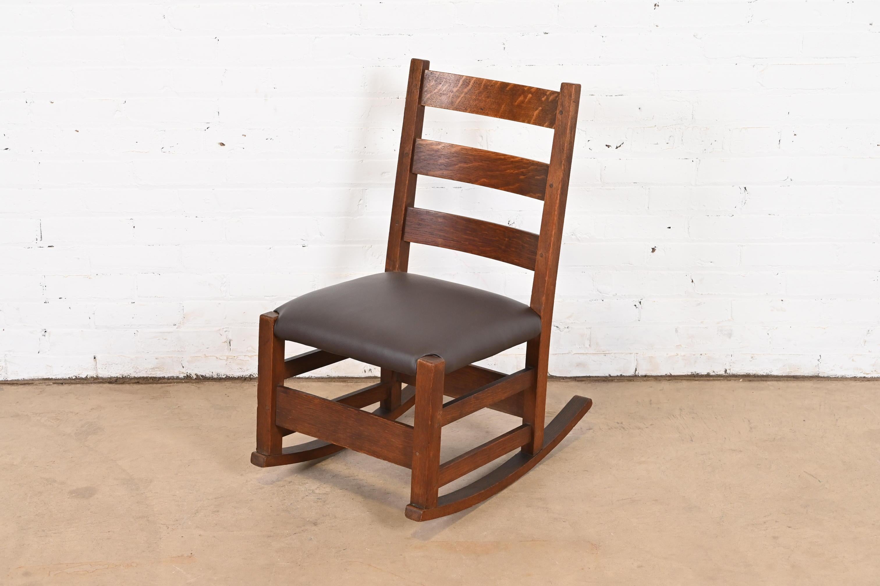 A gorgeous antique Mission or Arts & Crafts sewing or nursing rocker

By Gustav Stickley

USA, Circa 1900

Solid quarter sawn oak, with brown leather seat.

Measures: 17
