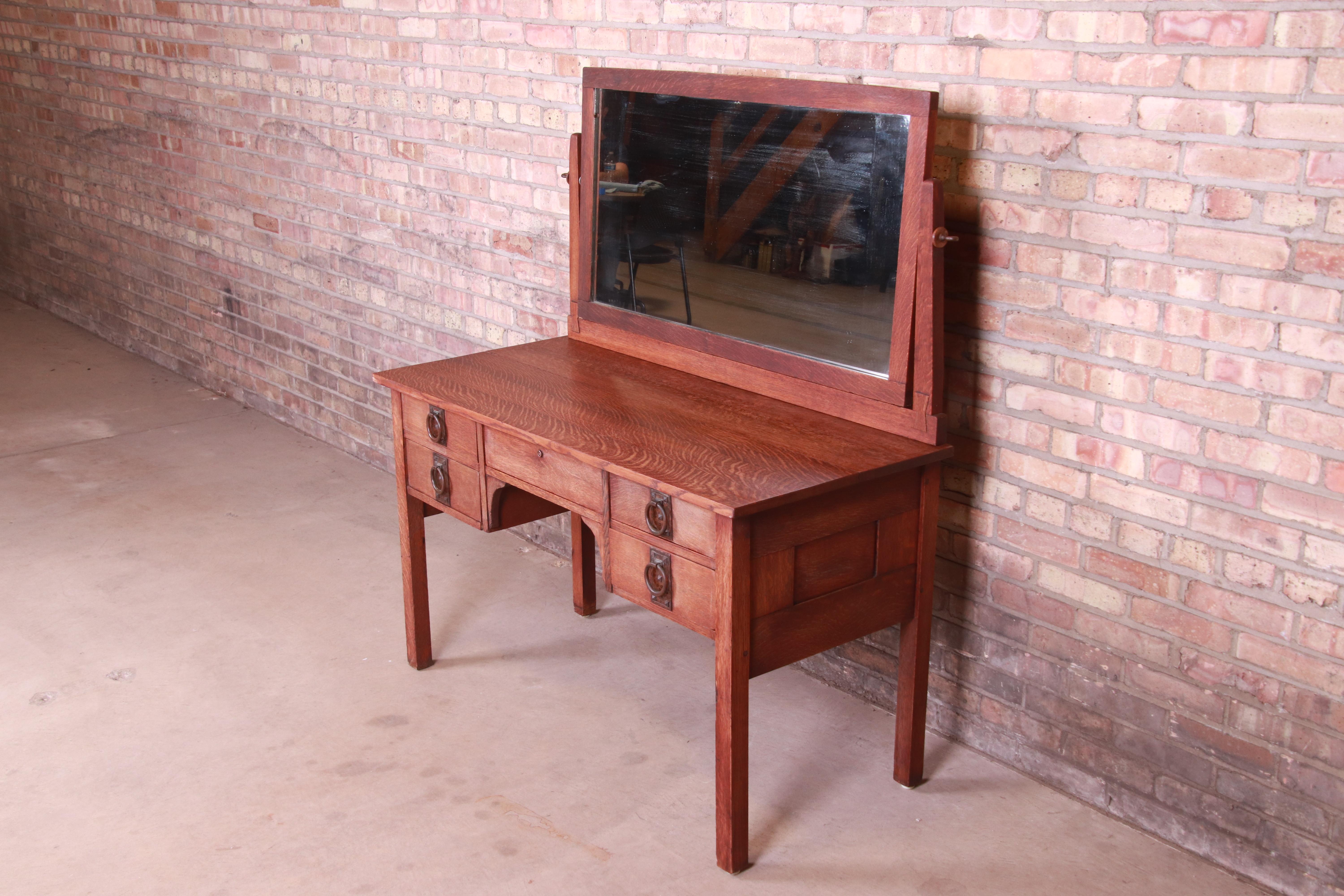 A rare and exceptional antique Mission oak Arts & Crafts vanity or dressing table with mirror

By Gustav Stickley

USA, Circa 1909

Solid quarter sawn oak, with original mirror, and original hammered copper hardware.

Measures: 48