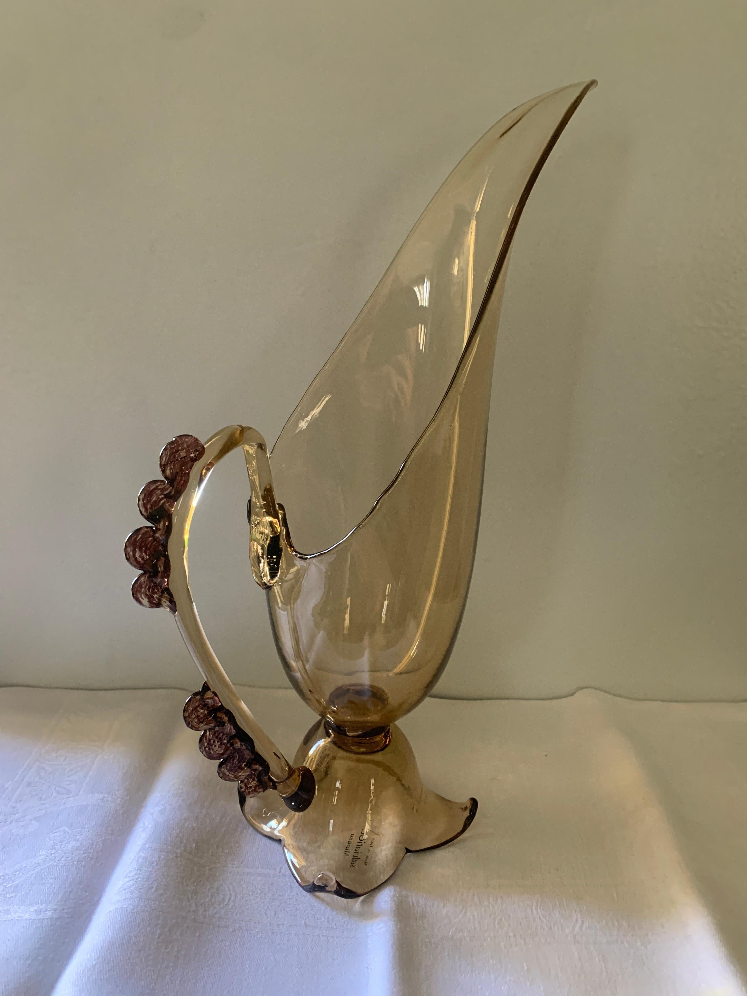 A wonderful pitcher hand blown by Vetri Murano Italy. The Amber Glass pitcher is footed and has a bead glass detail. Perfect for the sophisticated bar, juice or mixers - please see more of our hand blown Murano Decanters on our page.