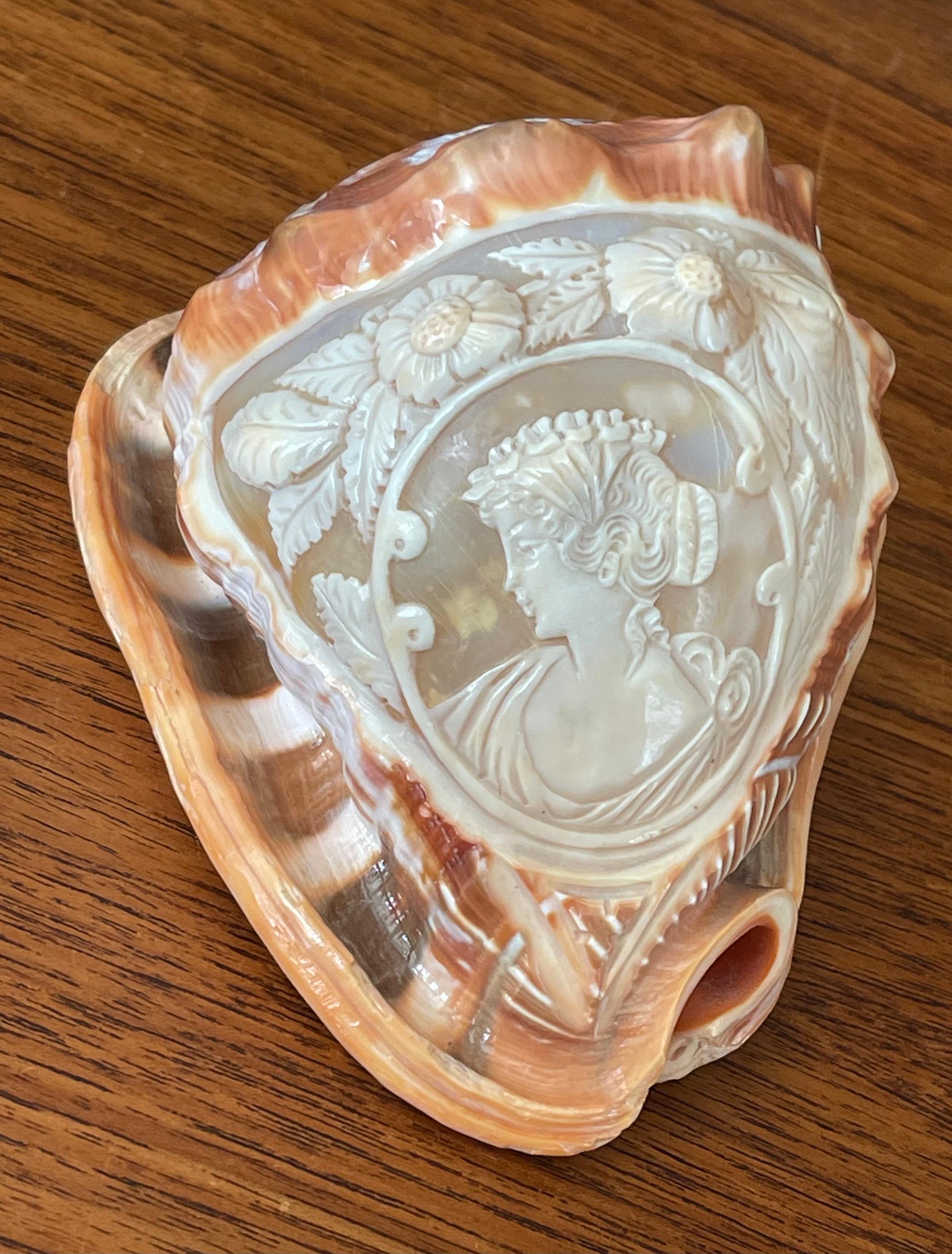 A beautiful signed hand carved cameo on conch shell made in Italy, circa 1980s. The piece is in excellent condition and measures 5.5