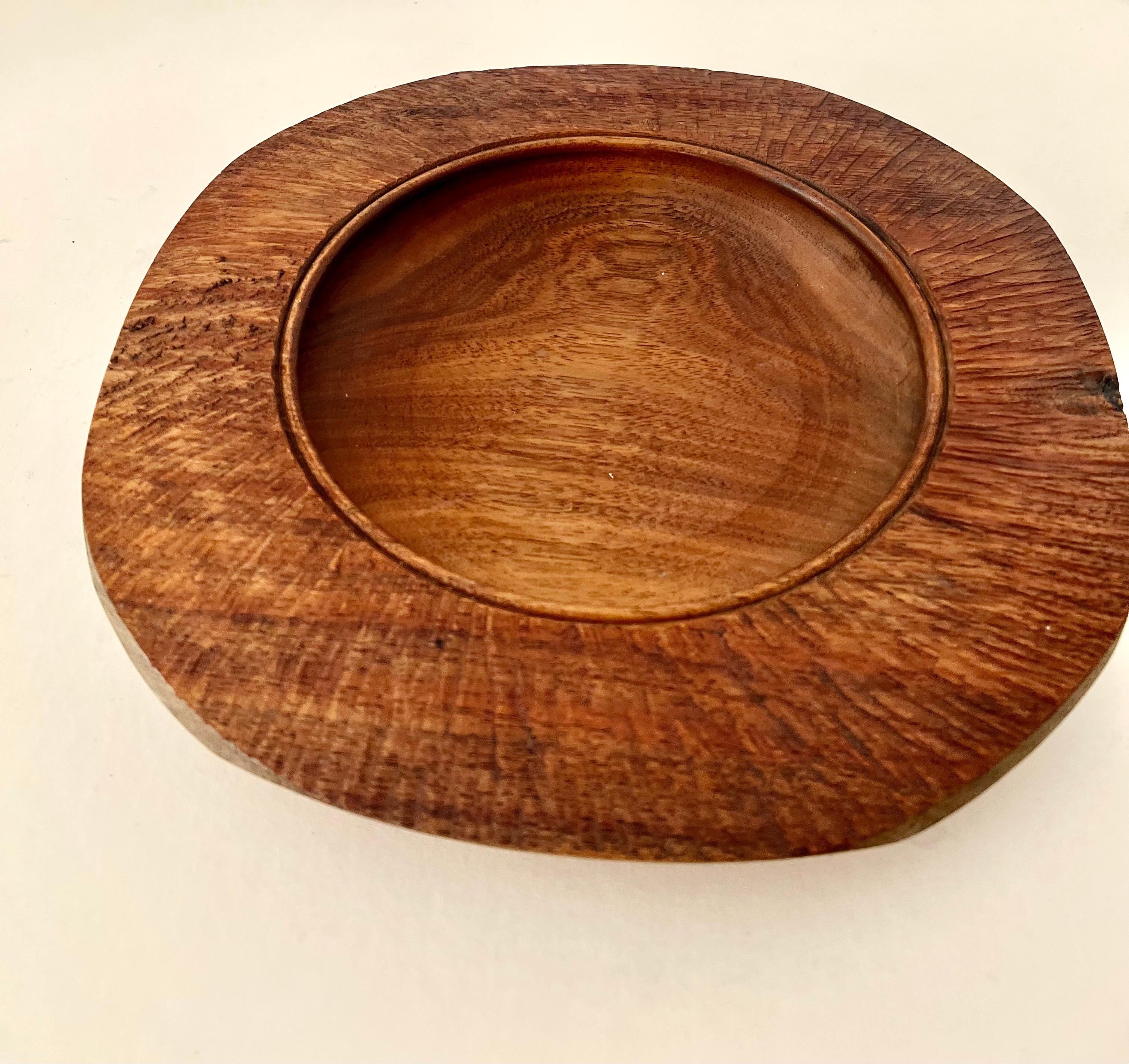 Hand Made New Zealand Blackwood / hardwood bowl. a 2.5 inch diameter of the outer rim is a remarkable rough hewn edge, while the inside that dips down to be a bowl or deep plate, is smooth and symmetrical.

A compliment to any natural setting, on