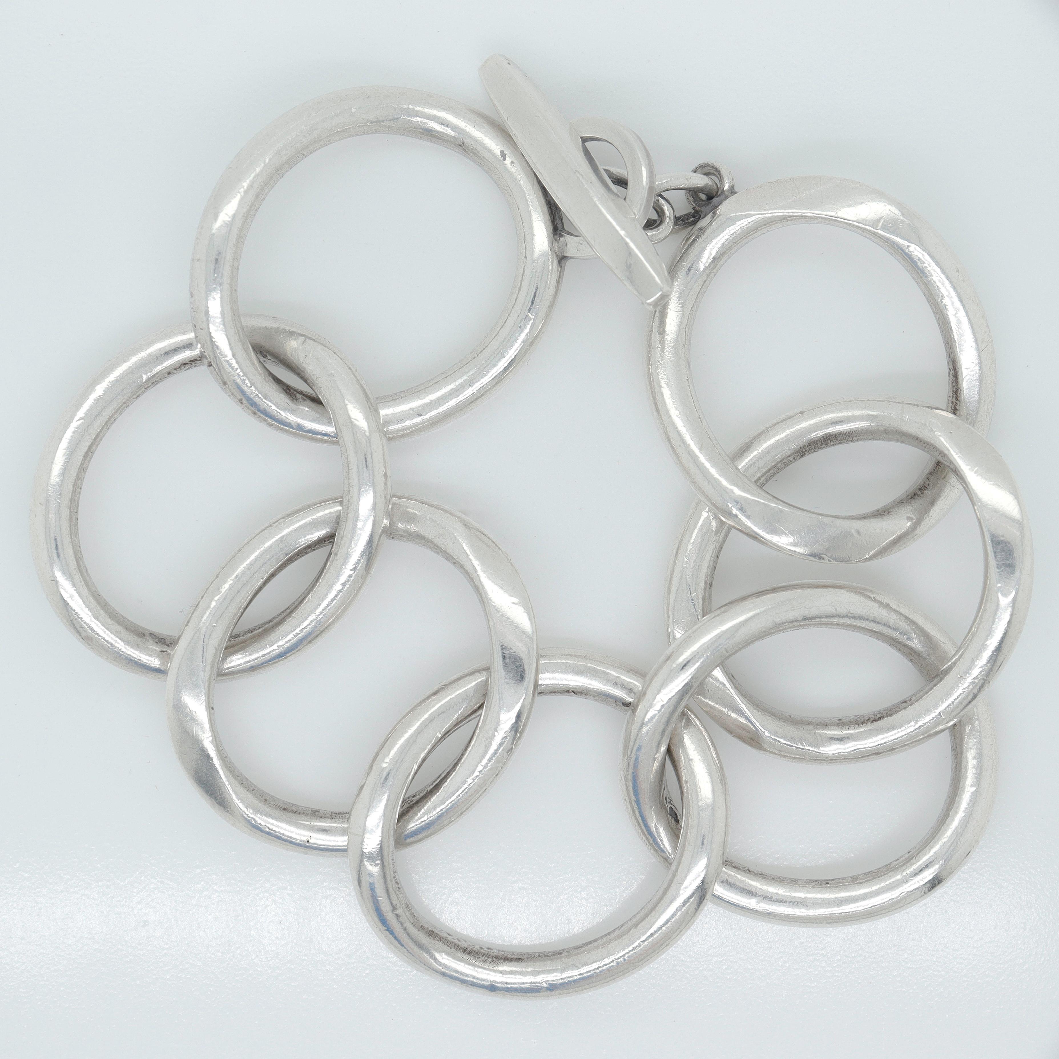 A fine signed Danish Modern chain link bracelet. 

In sterling silver.

Handmade by Randers Silversmith (Randers Sølvvarefabrik) in the 1960s or 1970s.

With large off-round chain links.

Secured with a toggle clasp.

Simply a wonderful Mid-Century