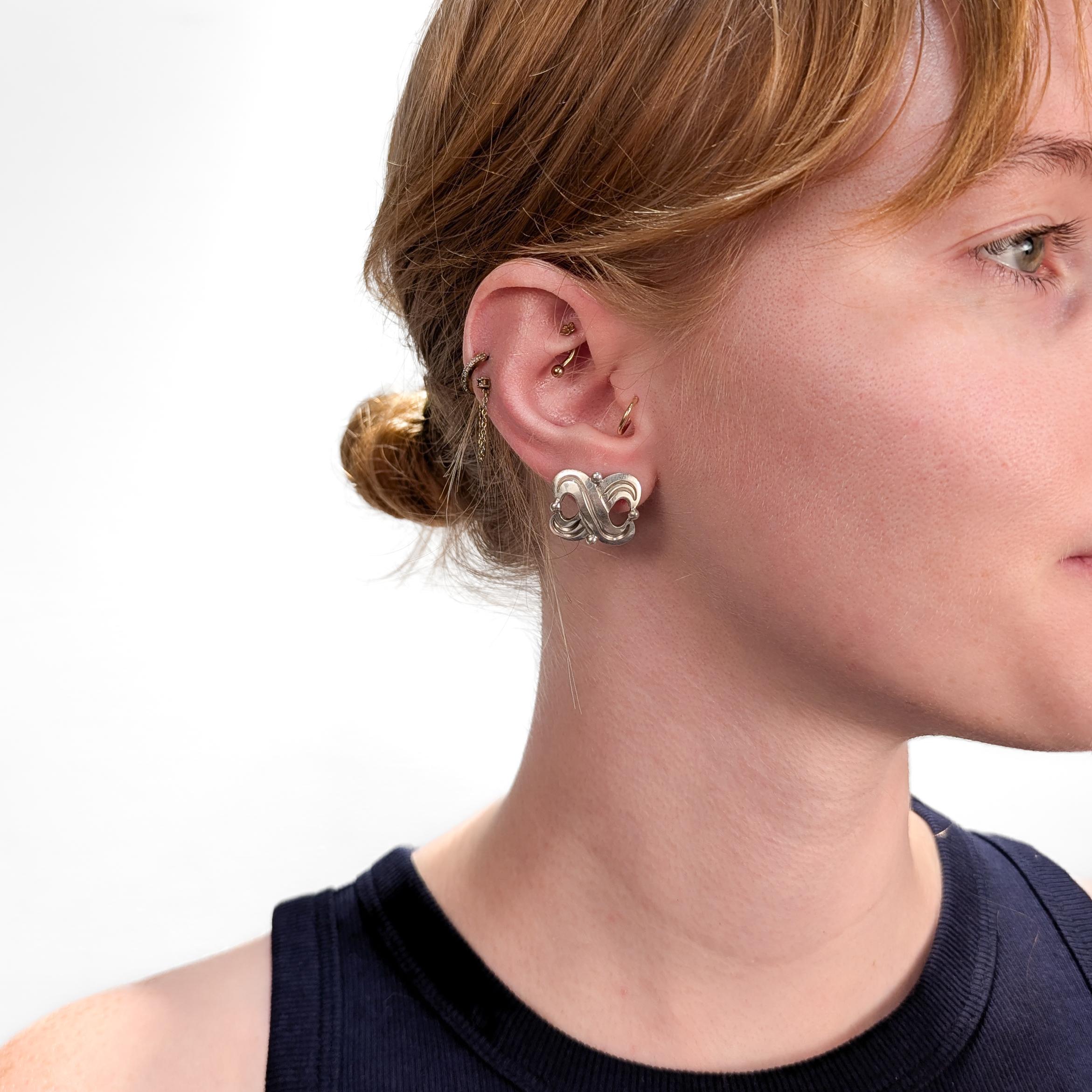 A fine pair of vintage signed Mexican silver earrings.

By Hector Aguilar.

In .940 sterling silver.

With screwback closures.

Marked to the reverse of each.

Simply a wonderful pair of high-level Mexican silver earrings!

Date:
Mid-20th