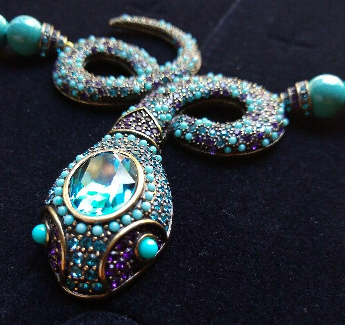 Chic and Dramatic, Designer faux Turquoise Necklace suspending a highly detailed Snake Serpent encrusted with faux Turquoise and pave-set sparkling Crystals. Signed HEIDI DAUS. Necklace measures approx. 25” long; chain allows adjustable length(s).