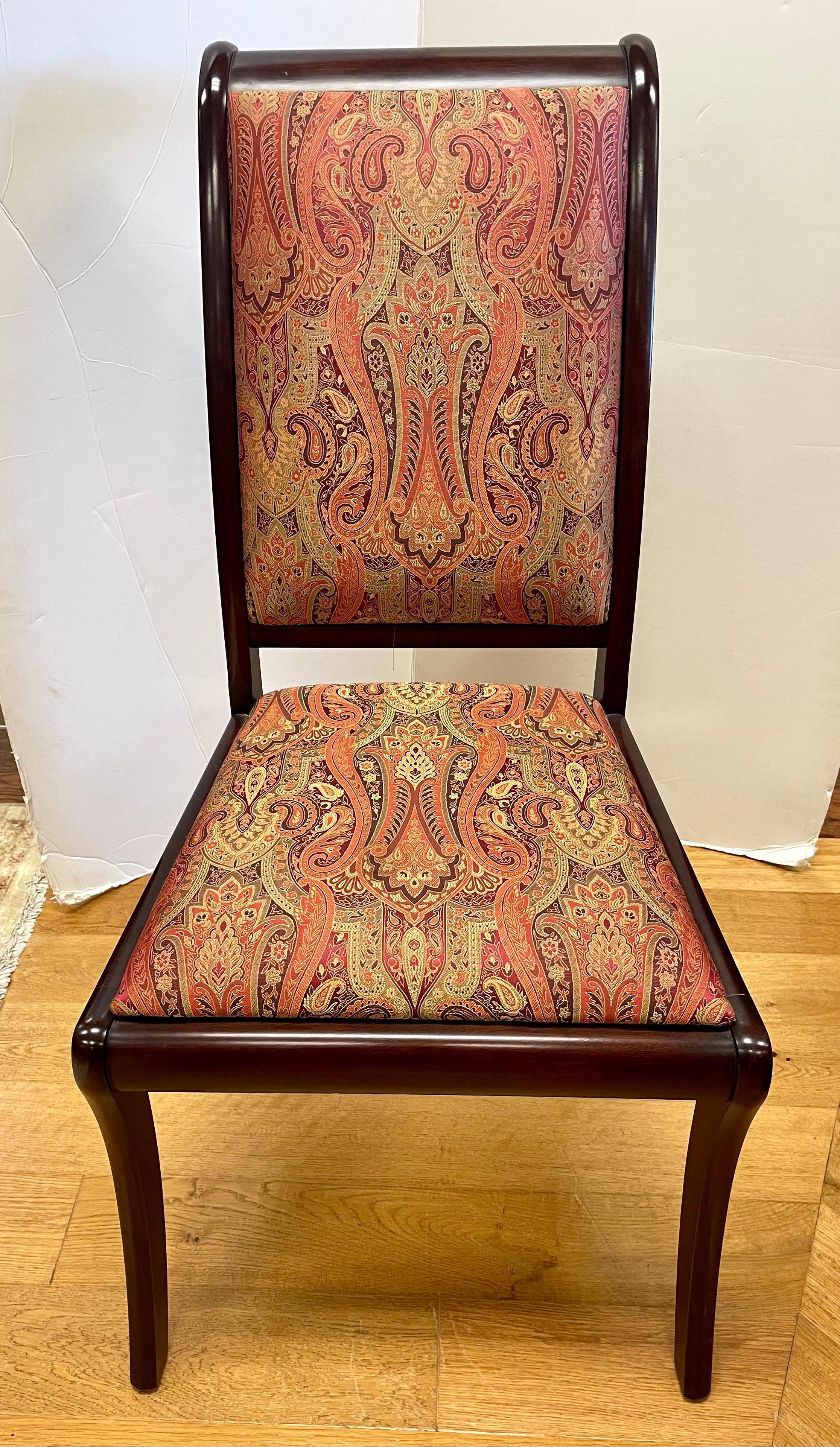 Set of 12 signed Henkel Harris mahogany dining chairs with stunning and luxurious red and gold paisley fabric. Style number is 201S and wood finish is 29. Henkel Harris makes some of the most luxurious and well crafted furnishings in the world.