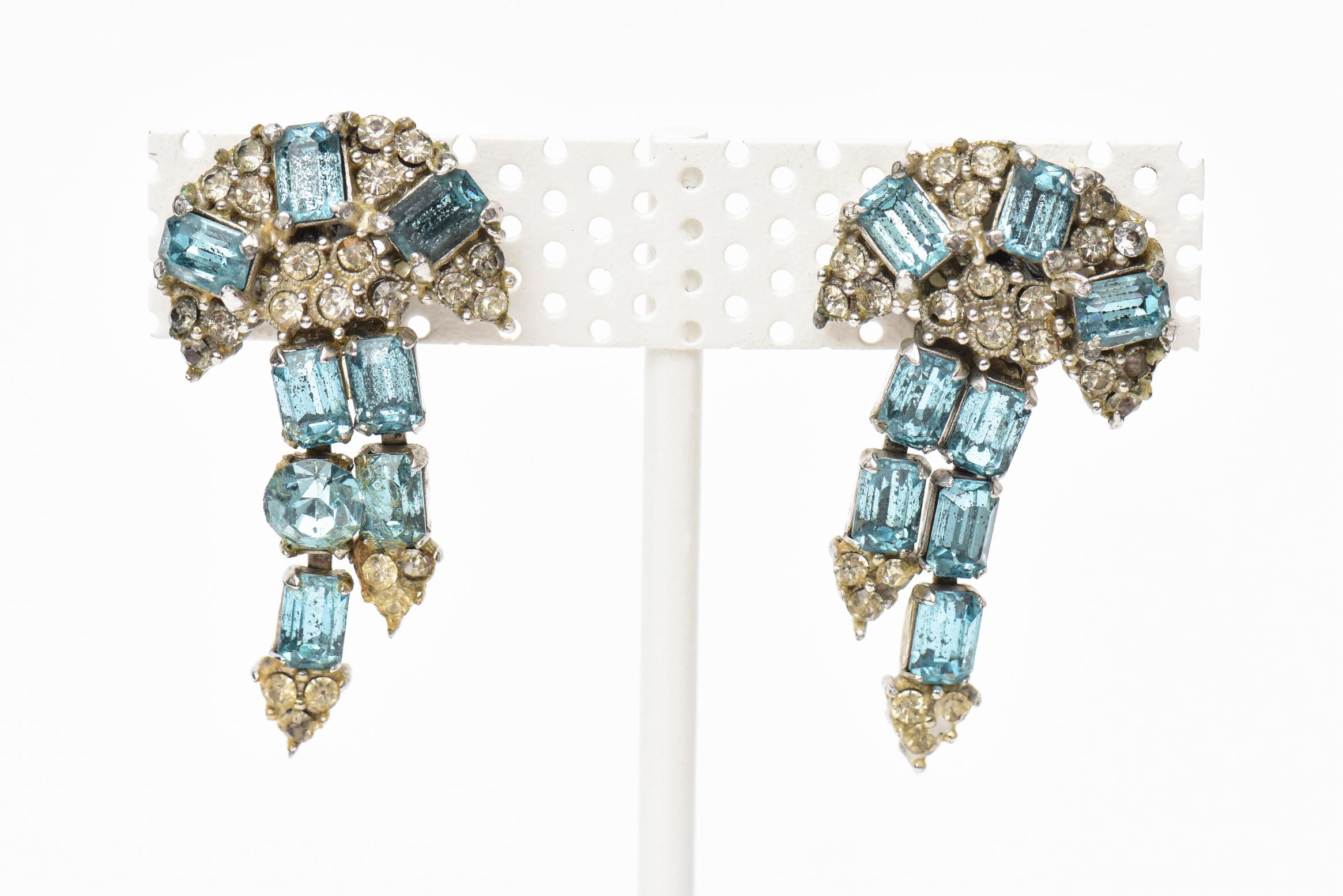 These lovely pair of signed vintage Hollycraft screw back dangle rhinestone earrings are elegant. The color of the light tiffany blue rhinestone is beautiful set against the clear. Can go dressy or casual. These are from the 50's. Flattering form