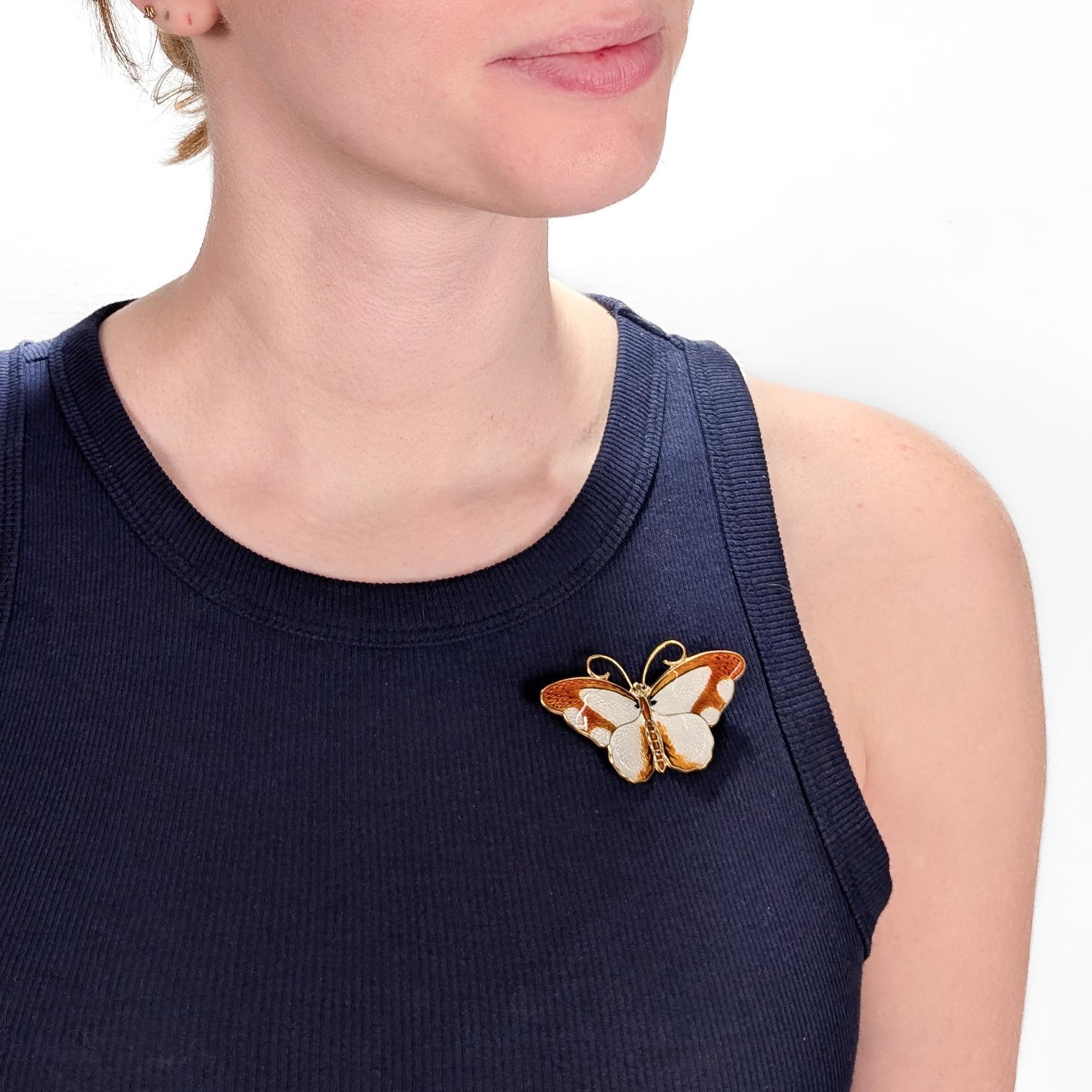 A fine, signed Norwegian butterfly brooch.

In gilt sterling silver.

By Hroar Prydz, whose workshop eventually became part of David Andersen.

In the form of a butterfly with orange and white enamels to its wings and body. 

Possibly modeled after