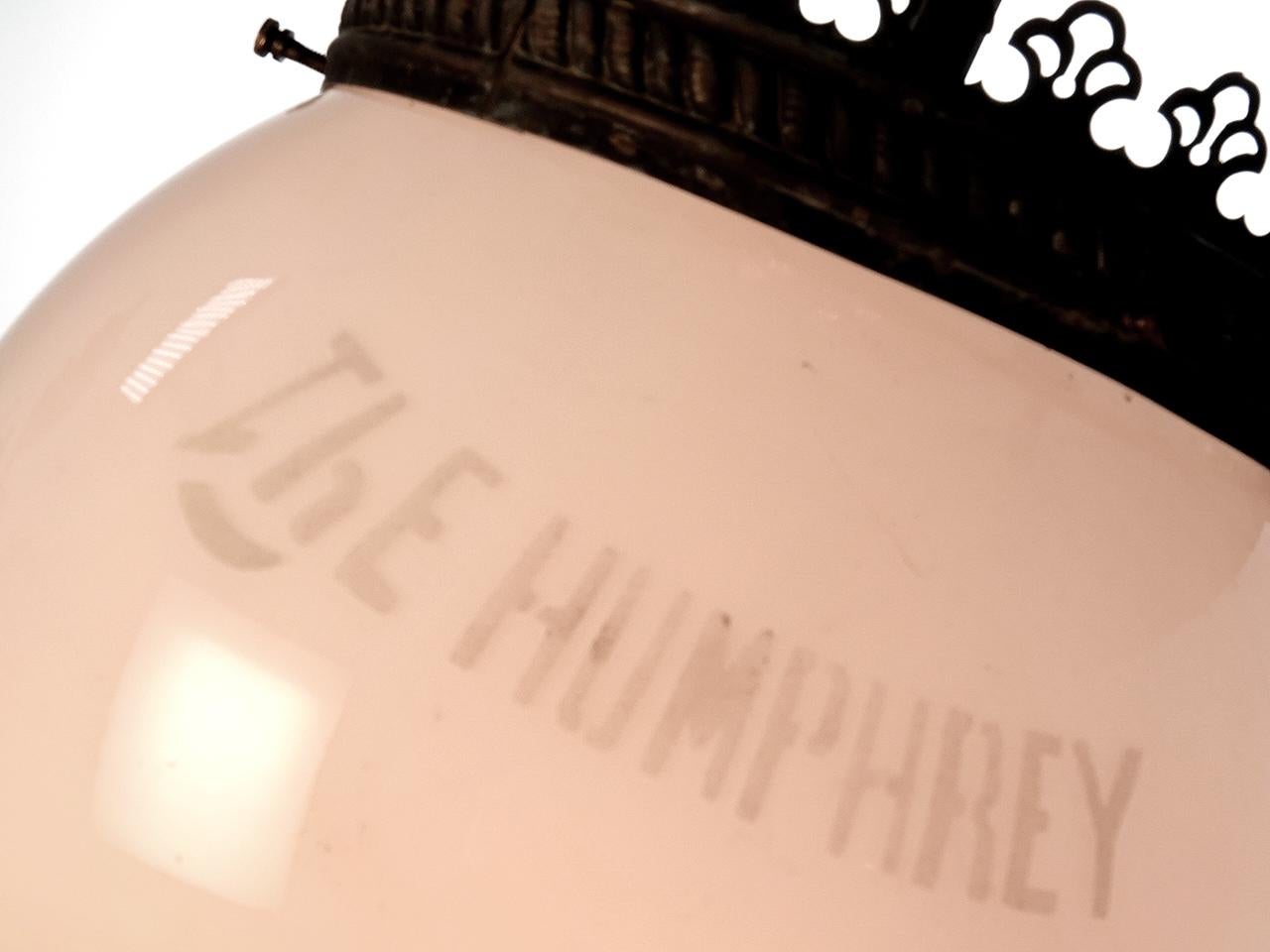 This early lamp is signed on the original glass globe and the brass base. Its one of Humphreys earliest lamps. The Humphrey Lamp Company has been around since 1901 and they are still manufacturing. Their large fixtures were used to light streets in