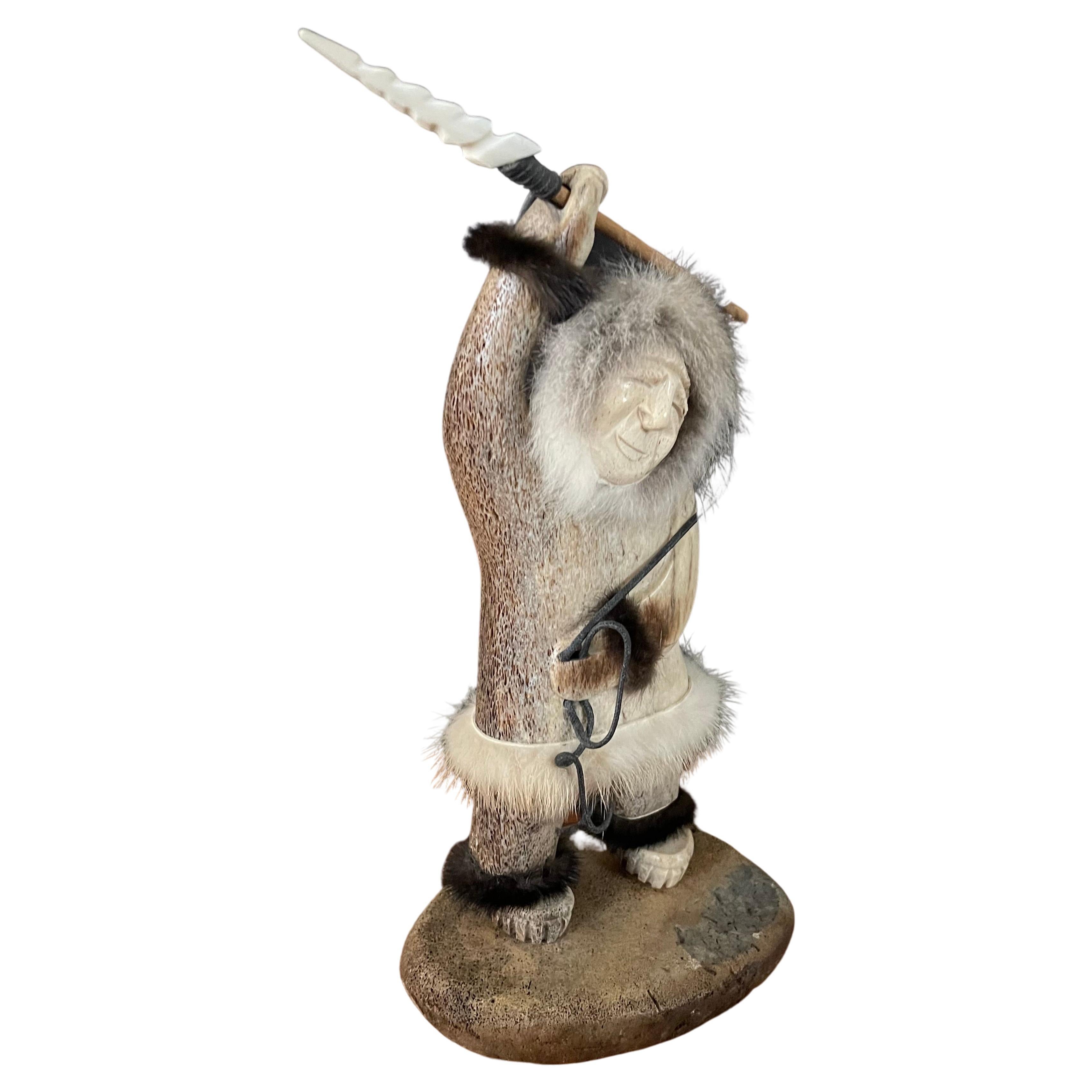 Incredible signed Inuit hand carved moose antler Eskimo fisherman sculpture, circa 1990s. The sculpture is incredibly well done crafted with fine detail and fur, leather and wood added. The piece is in very good vintage condition and measures 5.5