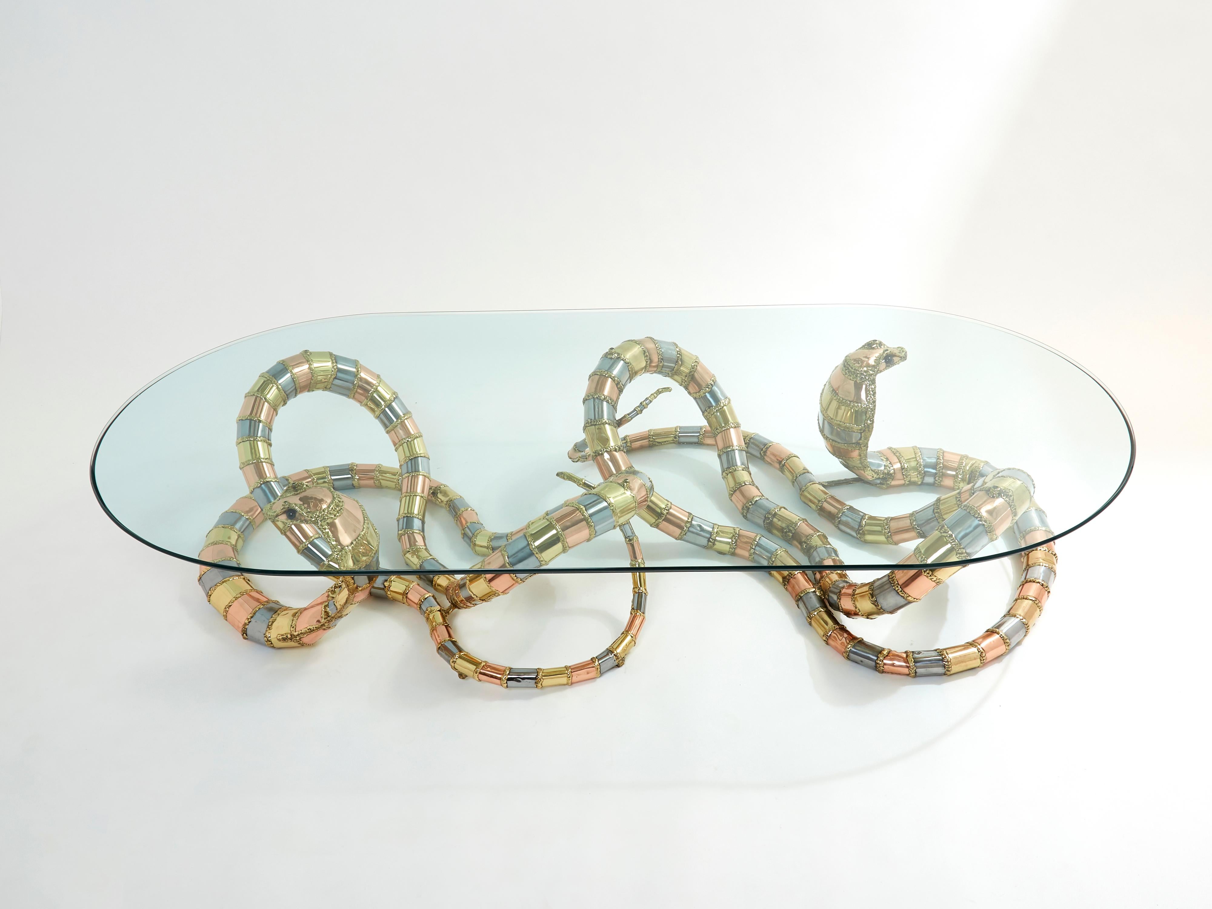 This unique sculpture coffee table signed by Isabelle Masson-Faure for Maison Honoré Paris in the late 1970s will make a fascinating centerpiece for any stylish living room. Formed with two metal sculptures in the lifelike shape of a cobra, this
