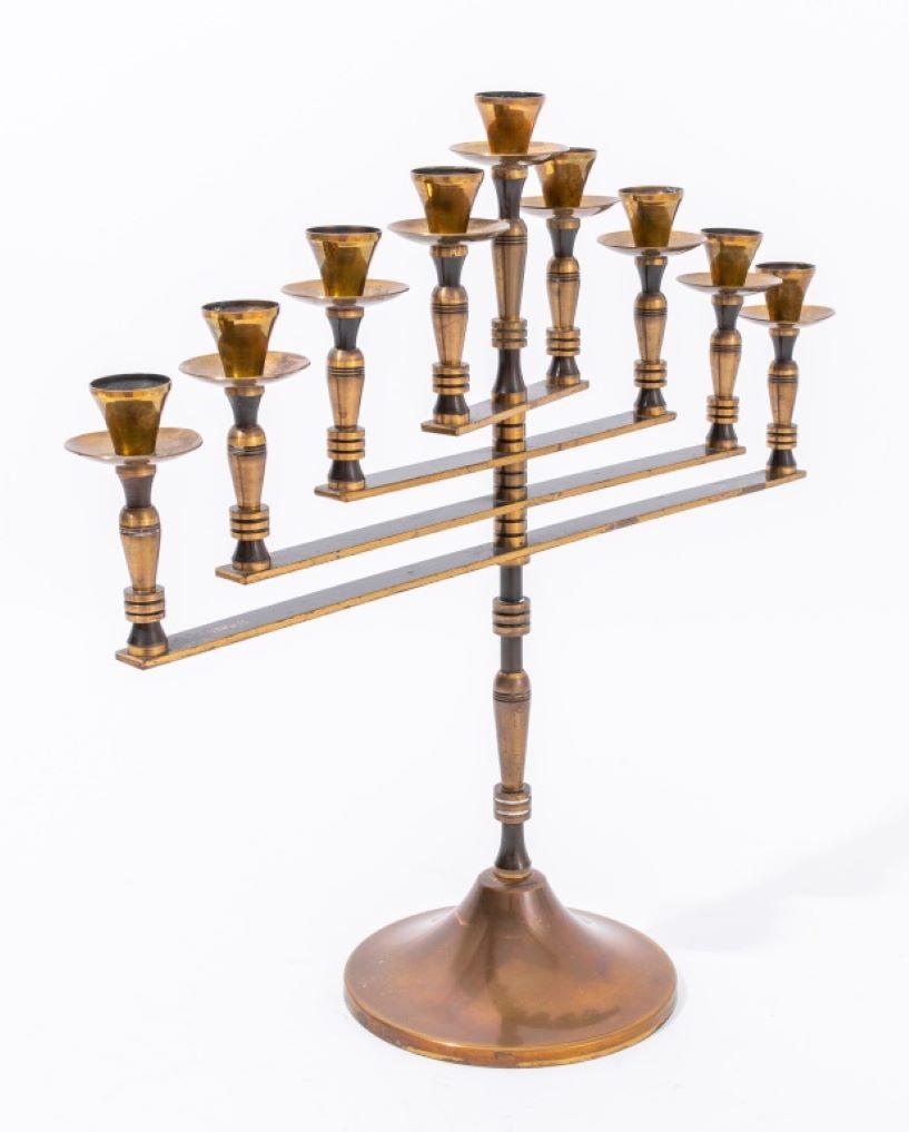 Judaica brass articulate menorah, made in Israel, signed by the artist in Hebrew, marked 