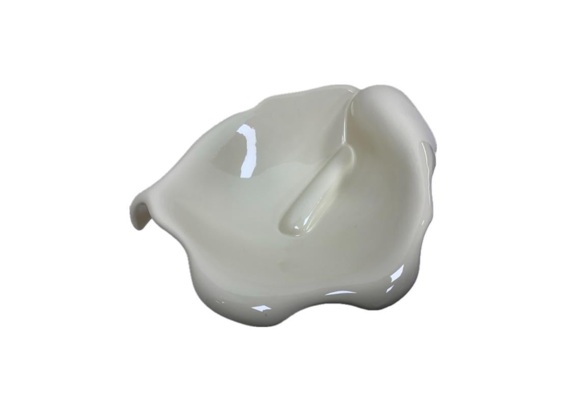A large and very sculptural white glazed ceramic bowl in flower form reminiscent of the work of both Georgia O’Keefe and Robert Mapplethorpe. With open form having out turned petals revealing the flower pistil within. Signed in the clay on the base.