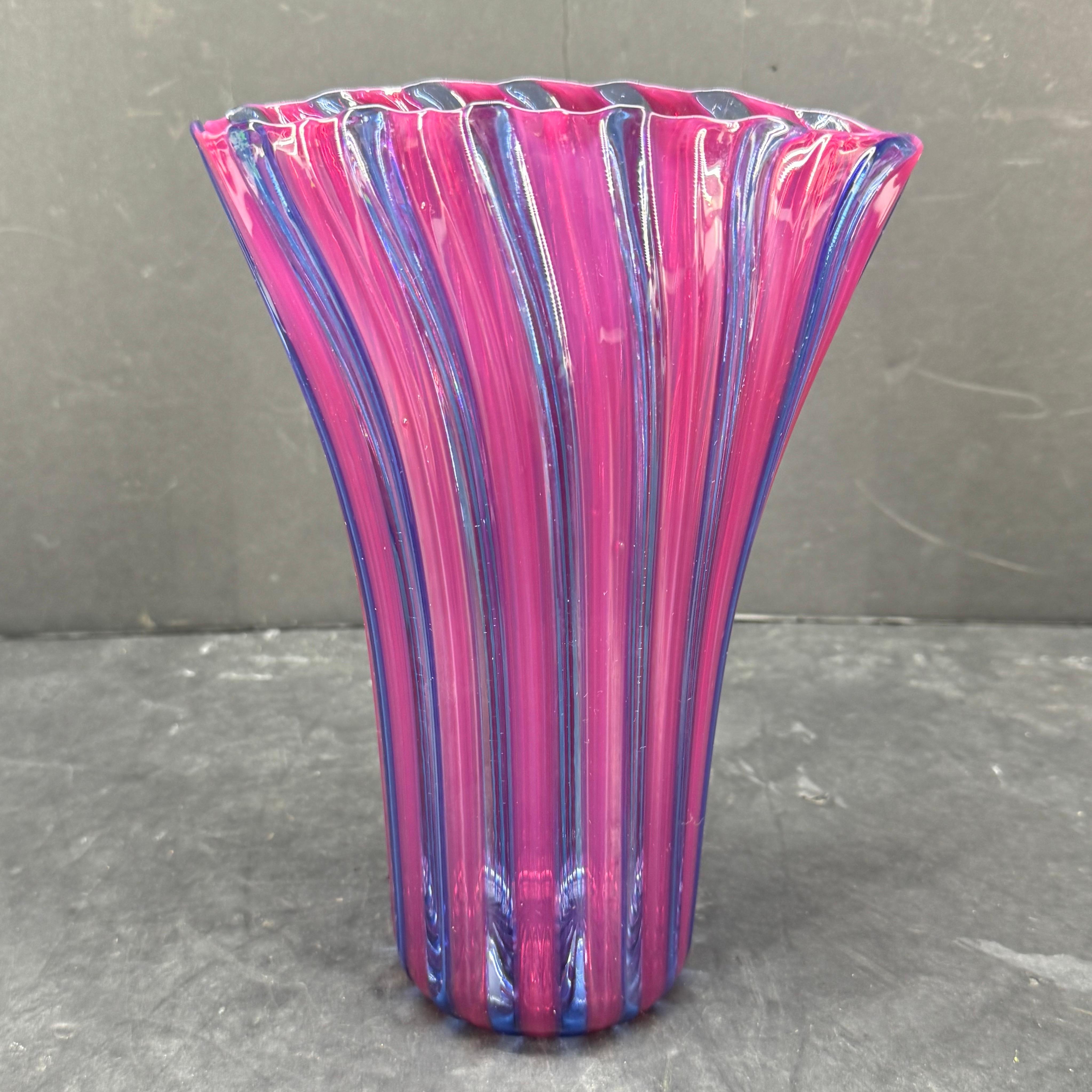Vintage Murano Italian art glass vase. This charming blue and purple vase has been hand blown with a colorful stripped pattern. This piece can be decorative as well as functional holding flowers. Signed on the bottom.