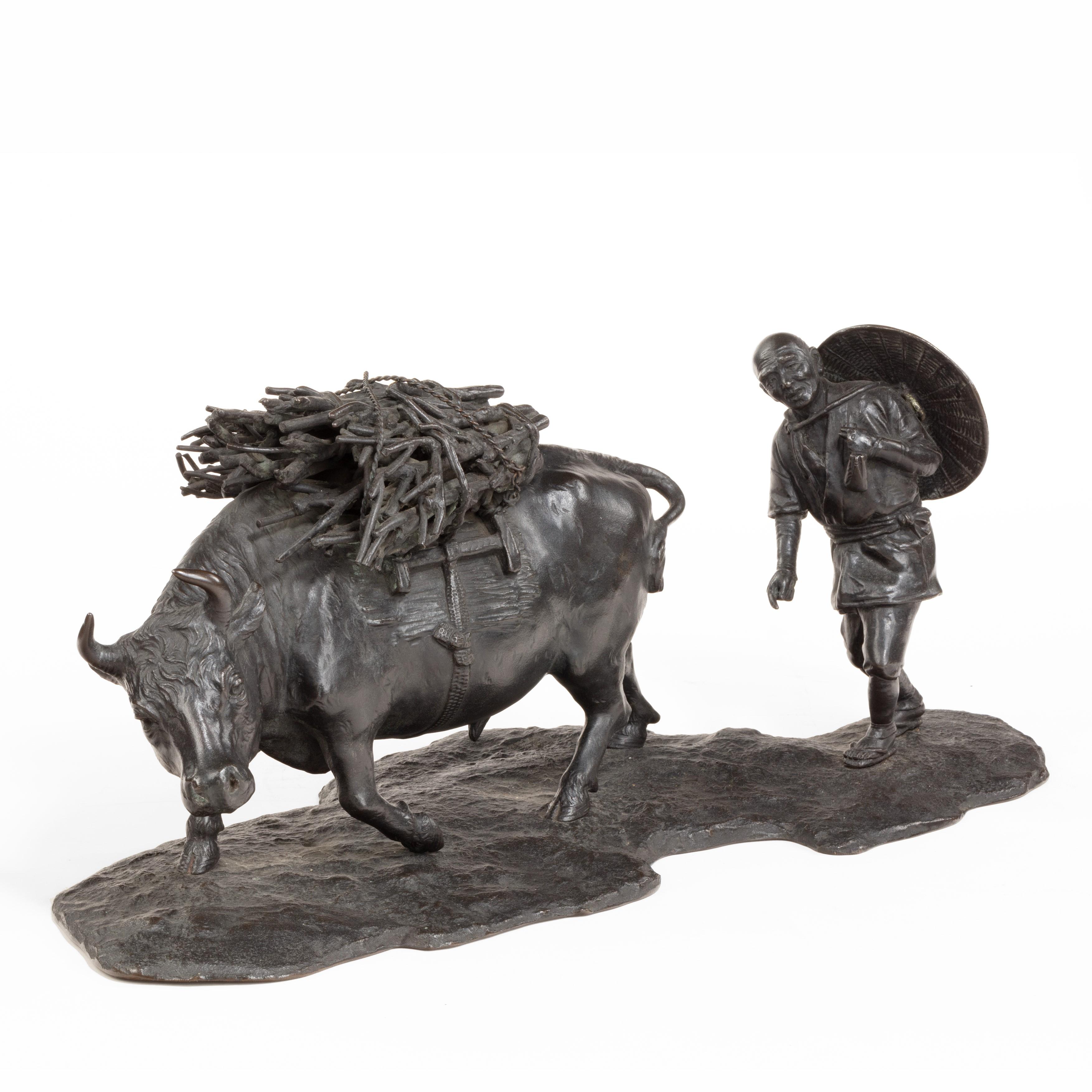 A signed Japanese bronze of a farmer with an ox, the man with a large hat slung over his back walking behind an ox with a bundle of firewood strapped to frame on his back, circa 1940.
Impressed signature.