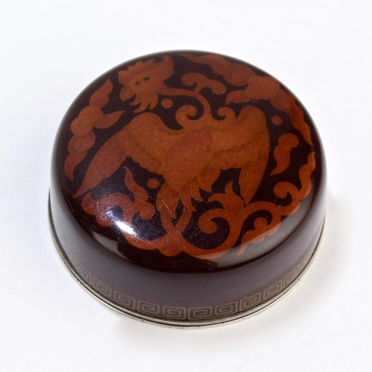 A fine, vintage Japanese cloisonné round box by Inaba. Possibly originally meant for incense.

A simple and compelling form of a fitted slide lid box with decoration of a phoenix and stylized clouds in orange and brown tones.

Dating to the at
