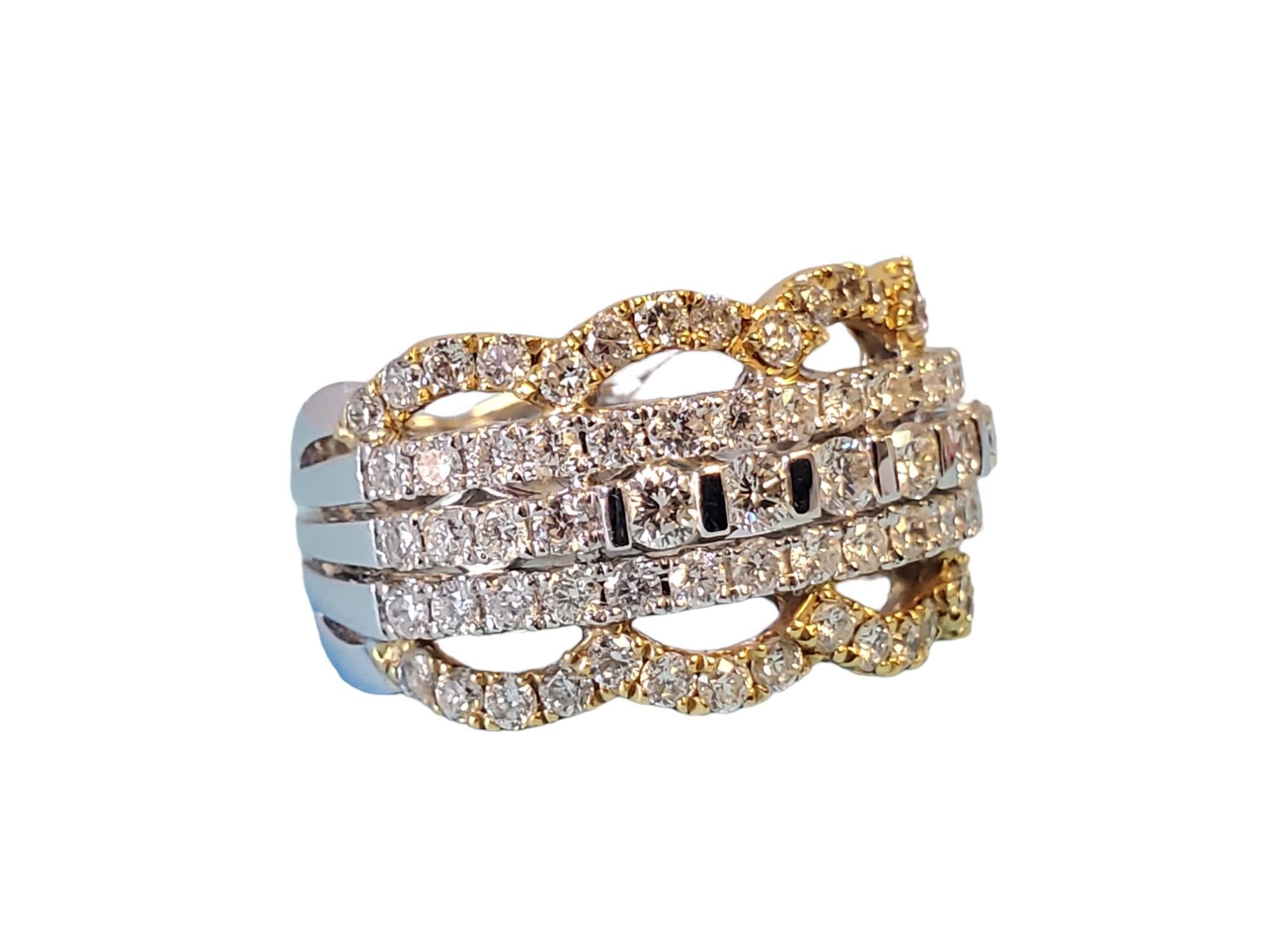 Listed is this beautiful unique 18k diamond band in 18k white gold with 18k yellow gold designs added in. This ring features high end 1.74tcw white vs diamonds throughout with life and sparkle. The band is solid and well crafted with a 12mm width on