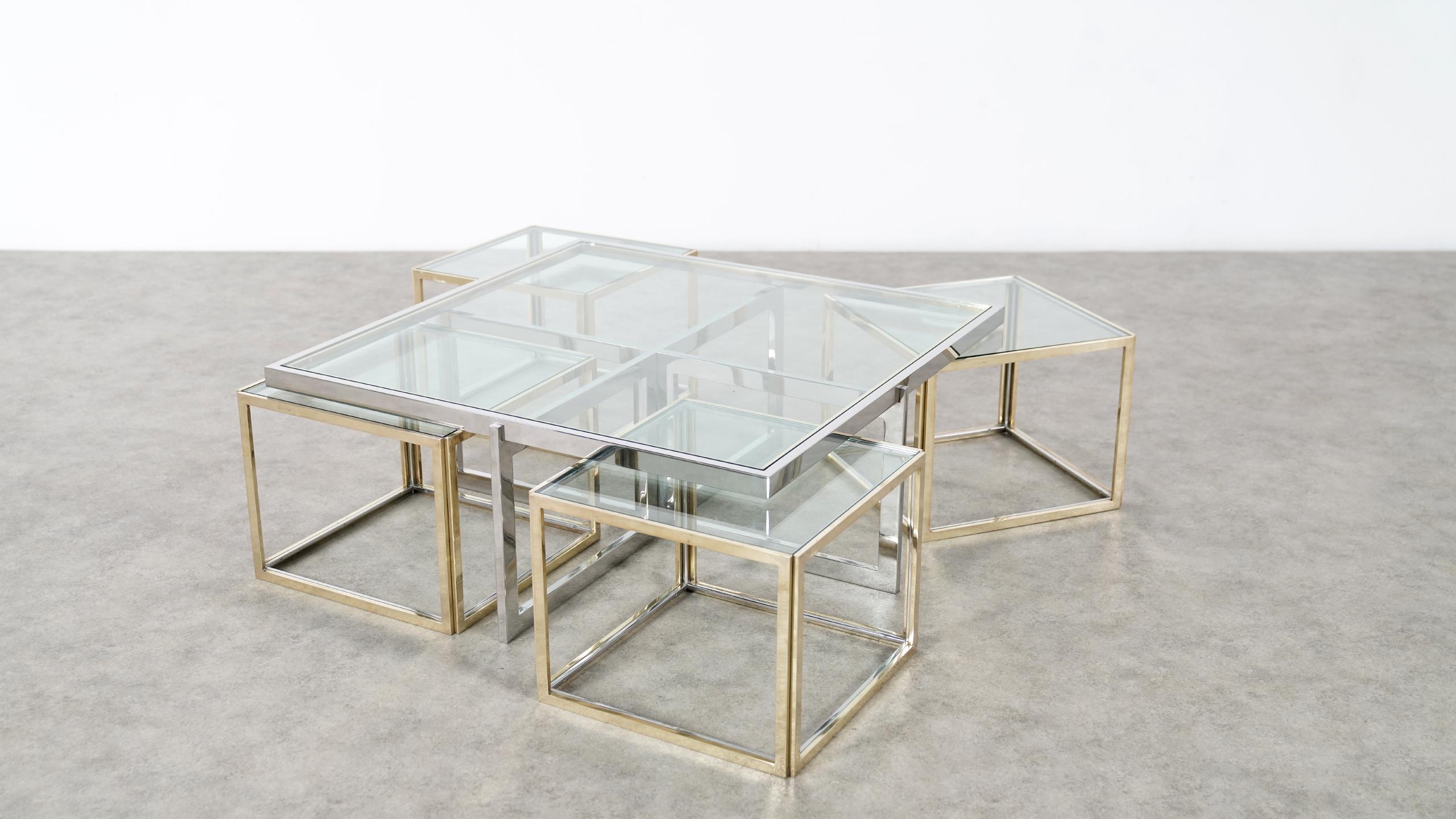 Elegant chrome and glass coffee table with four nesting tables in brass and chrome, designed by Jean Charles, made by Maison Charles. 
This set is extremely rare, as every table is signed & stamped Jean Charles on one side...!!

The tables are in
