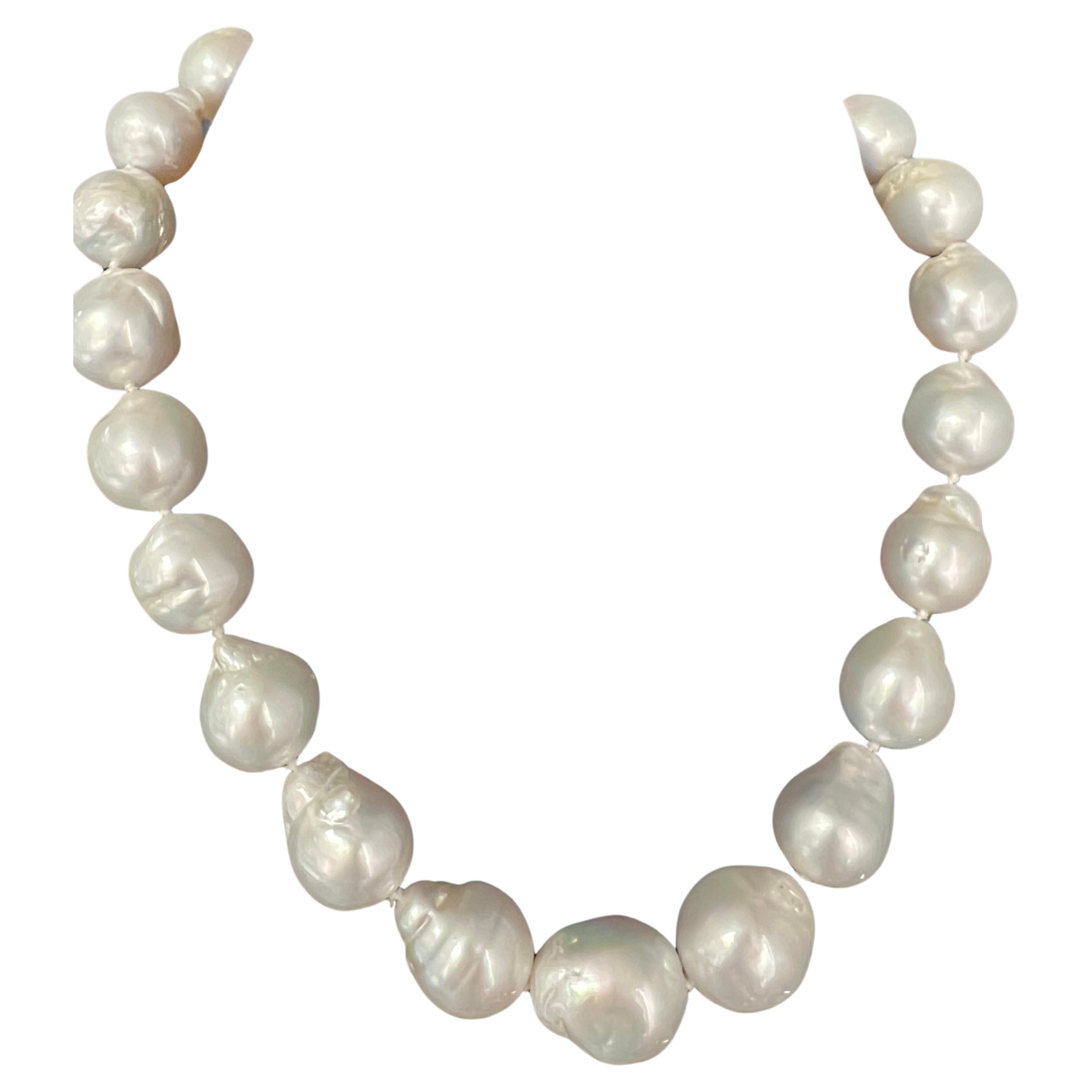 A magnificent Australian South Sea Cultured Baroque Pearl Necklace set in a graduating strand of 23 pearls measuring approximately 14mm to 17.5mm. The pearls have excellent luster and are white. 

The strand includes an 18k yellow gold matte finish