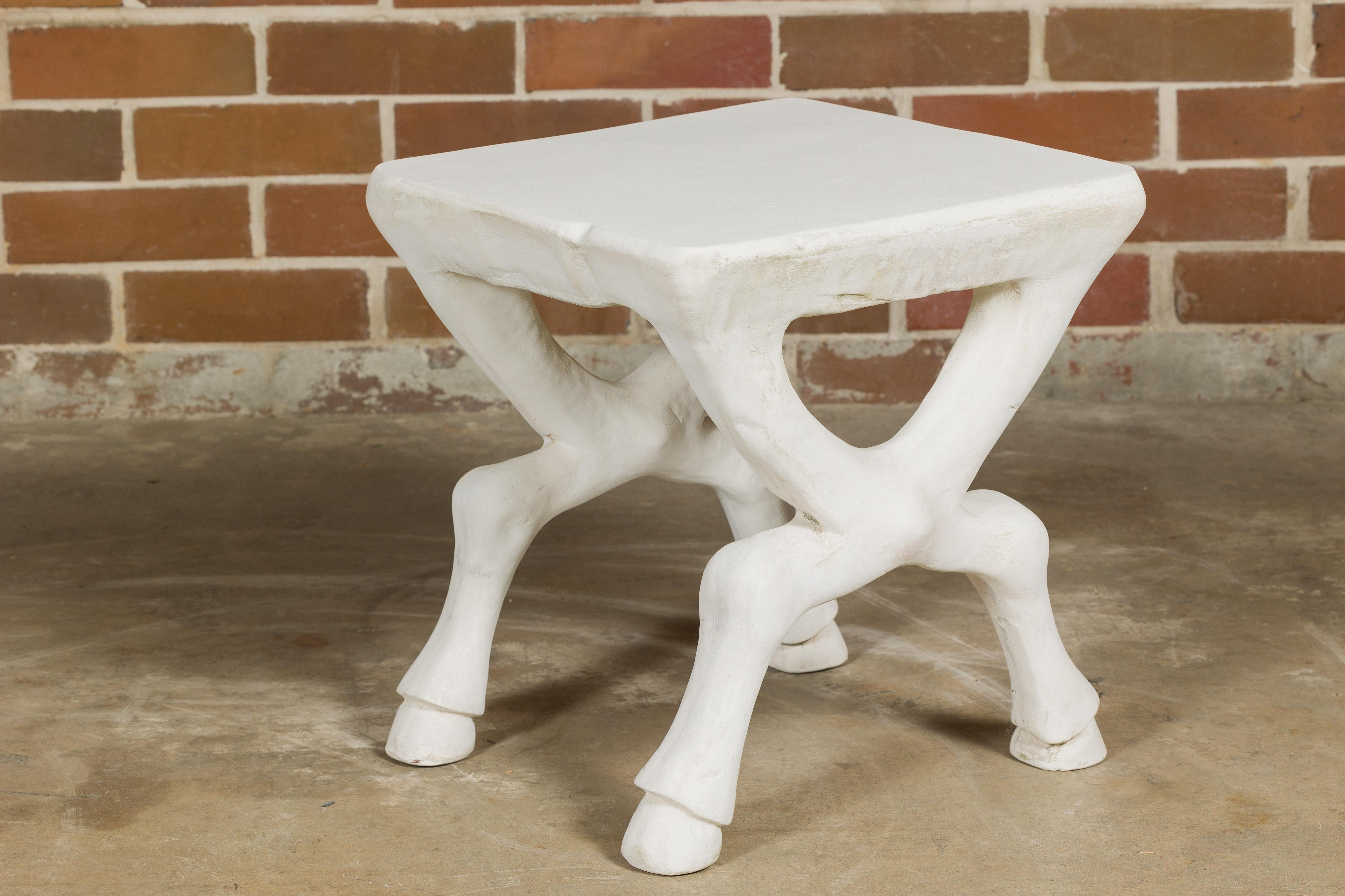 A signed John Dickinson plaster low side table from circa 1970 with white finish, X-Form base and hoof feet. This iconic John Dickinson plaster low side table, dating back to around 1970, exudes a timeless elegance with its distinctive design.