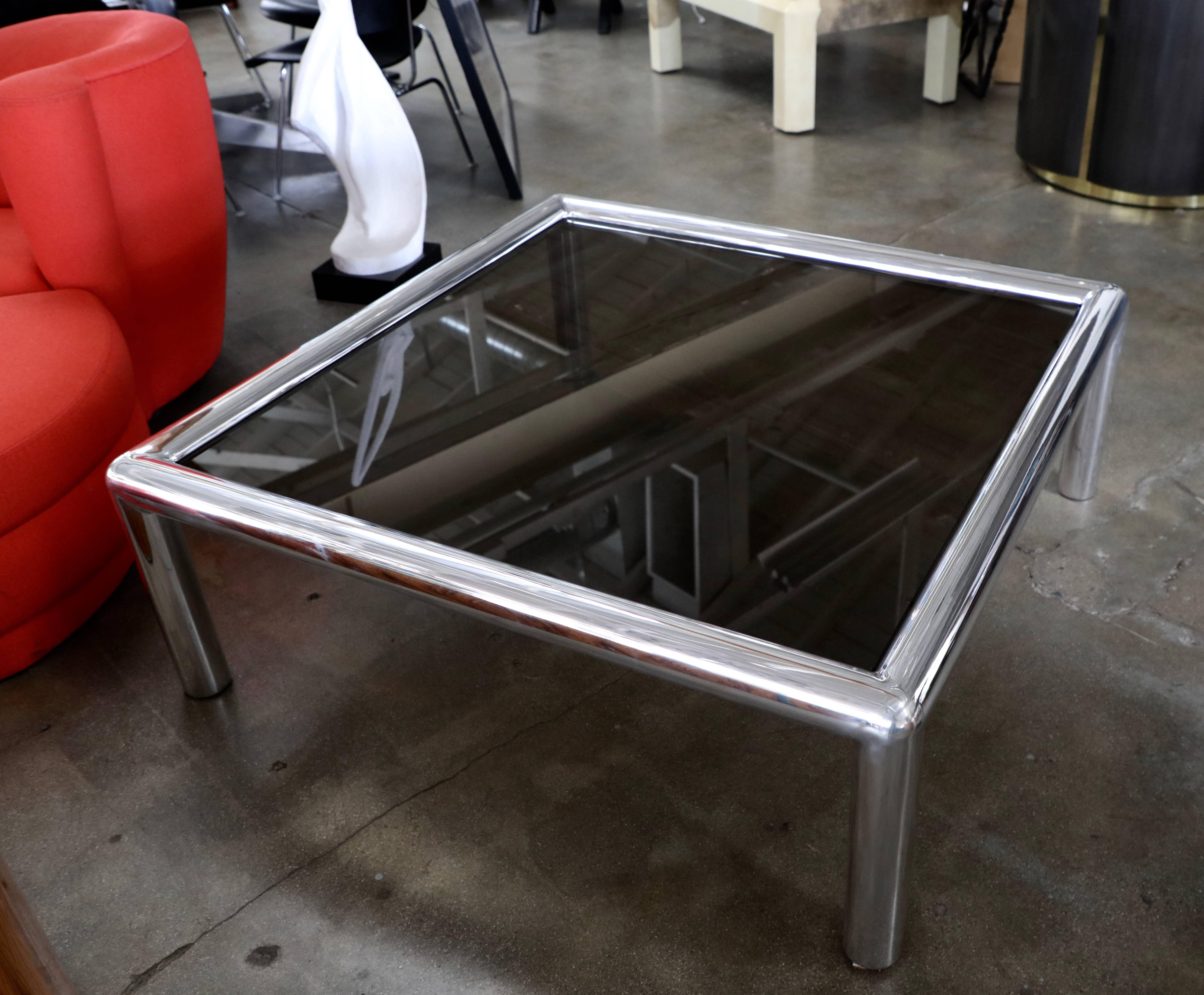 A nice polished out signed John Mascheroni aluminum table. We bought new glass that they describe as bronze color. Even though it has been polished there are still some imperfections and scratches.