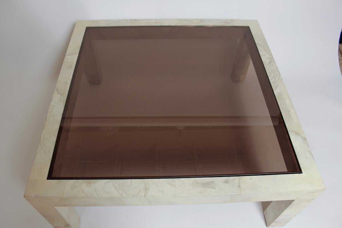 Elegant Parson's style coffee table by Karl Springer in matte-finished, pale bleached goatskin with contrasting smoked glass top, circa 1980. Leather maker's label.