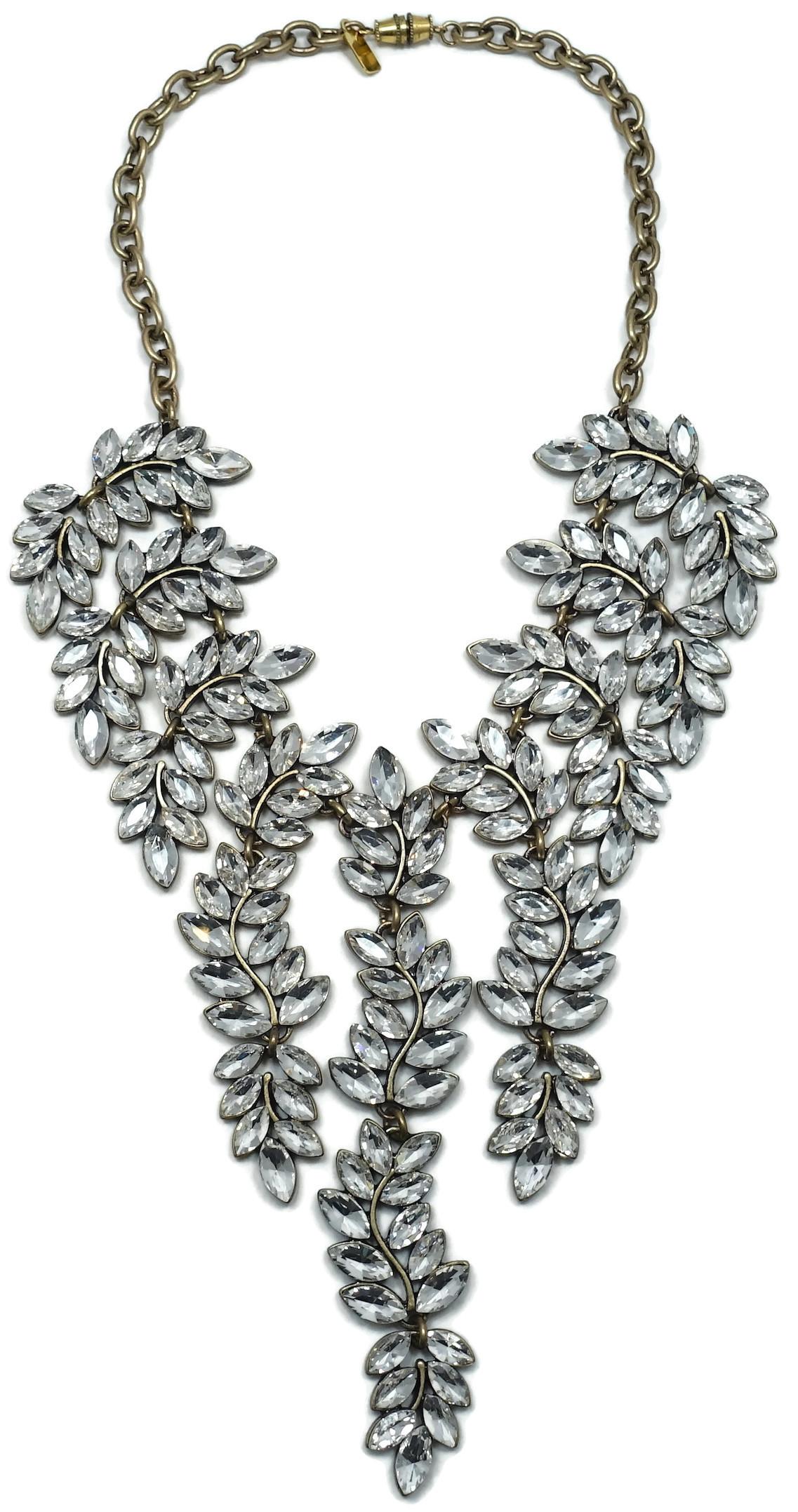 This famous signed Kenneth Lane necklace features multiple leaf drops with crystal accents in a gold tone setting.   This book piece necklace measures 16-1/2” long with a screw barrel closure; the center drop is 5-1/4” long x 1”.  In excellent