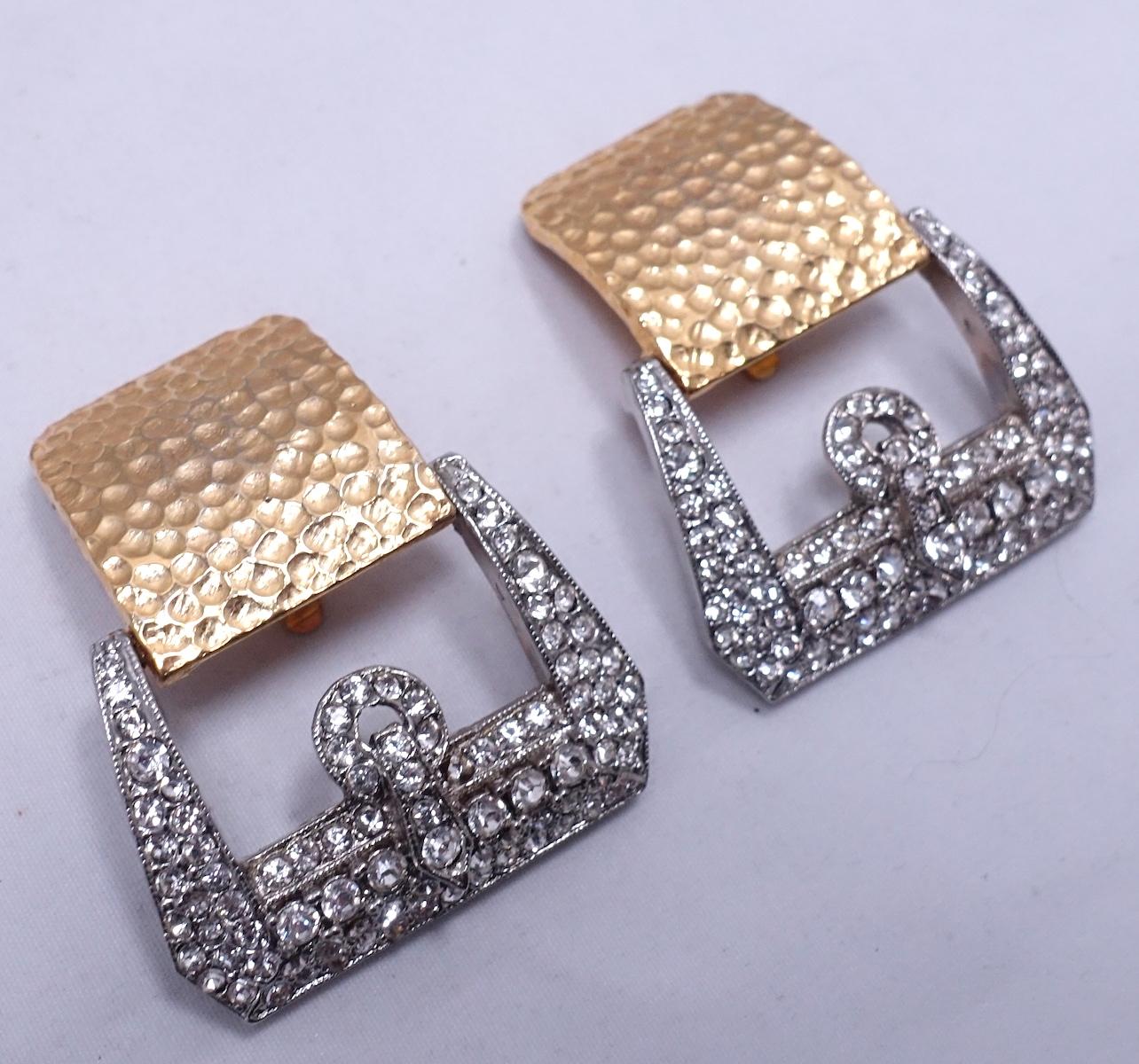 This signed Kenneth Lane earrings feature a buckle design with clear crystal accents in a mixed metal of gold & silver tone.  In excellent condition, these clip earrings measure1-7/8” x 1-3/8” and are signed “Kenneth Lane”.