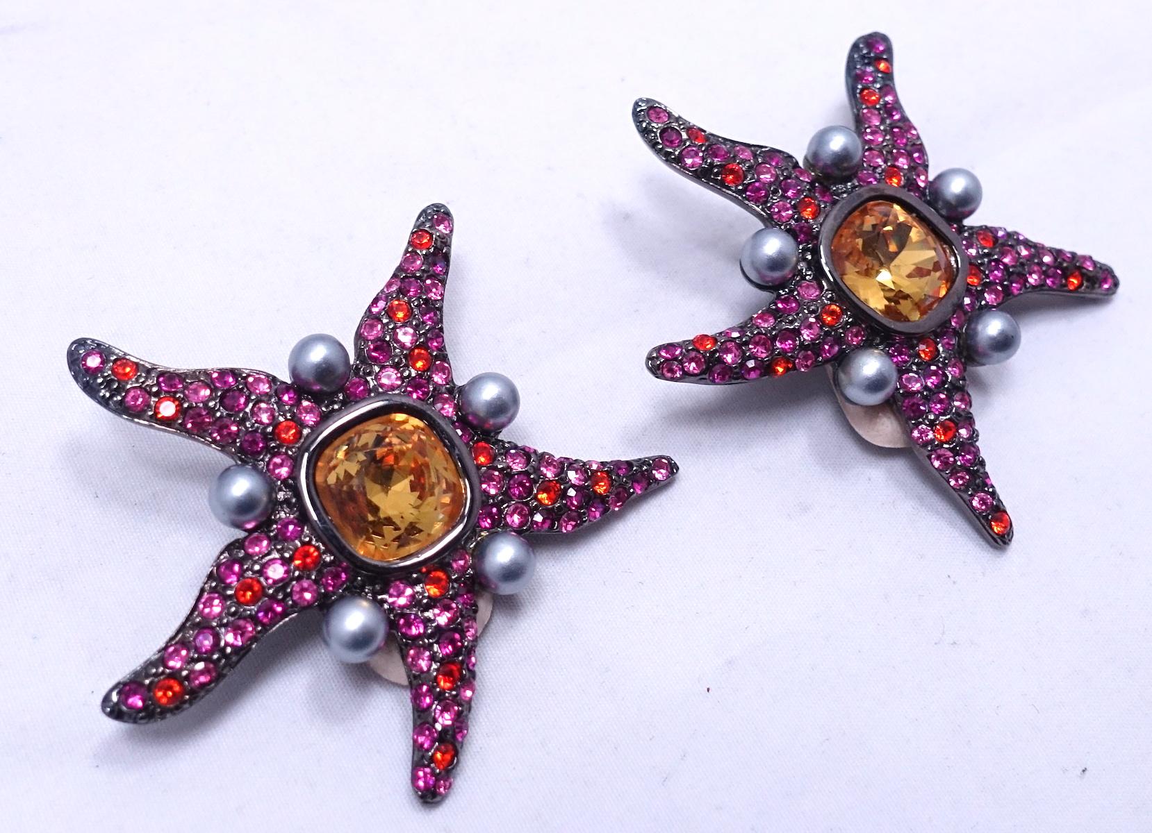 These signed Kenneth Lane starfish earrings are made with pink and citrine color crystals in a japanned setting.  In excellent condition, these earrings measure 2” in diameter and are signed “Kenneth Lane”.