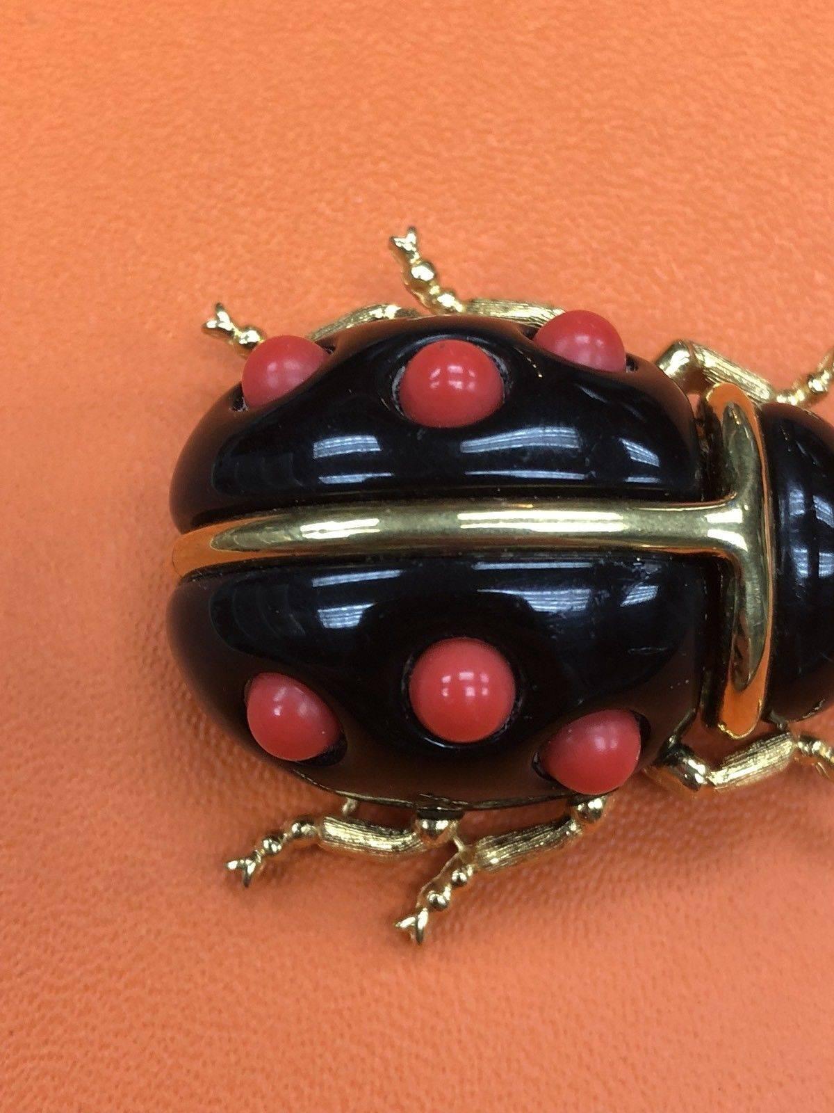 Delightful Ladybug brooch adorned with Faux Coral; signed on reverse: KJL; measures approx. 1.75