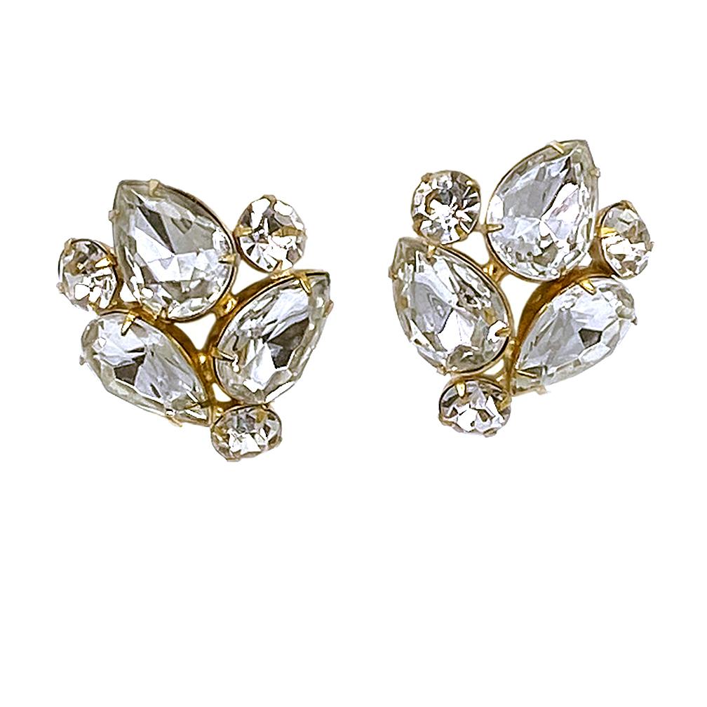 This is a pair of signed KLJ clear rhinestone clip-on earrings These 1980s cluster earrings each have three large pear shaped stones and three smaller chatons. All are prong set on gold-tone metal by designer Kenneth Jay Lane.

Our vintage jewelry