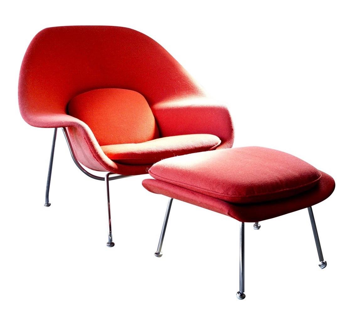 Iconic, authentic and with lines that are an architectural wonder, this sculpturally designed, original Womb chair and accompanying ottoman is by famed Finnish/ American designer Eero Saarinen and produced by Knoll. The chair and ottoman both retain