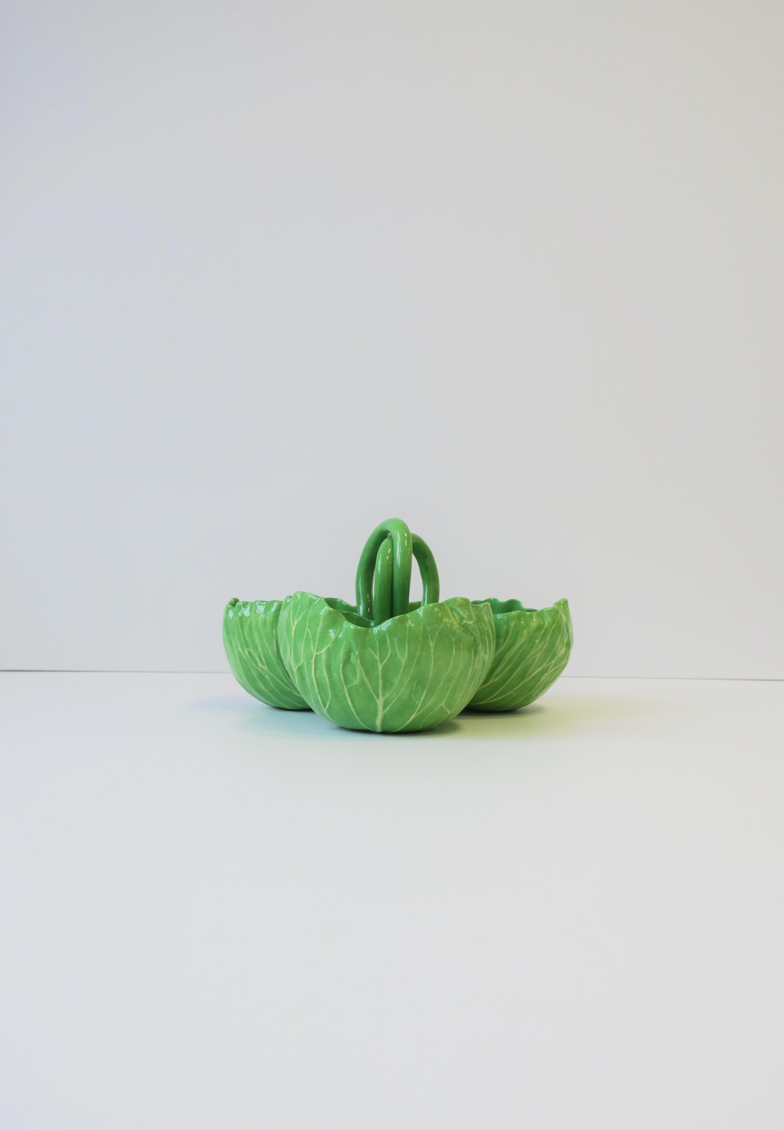 A beautiful and rare signed Majolica style 'Lettuceware' pottery serving dish by Designer Dodie Thayer, circa 20th century. Piece is comprised of three 'lettuce' cups or bowls with each measuring Approx. 4.5