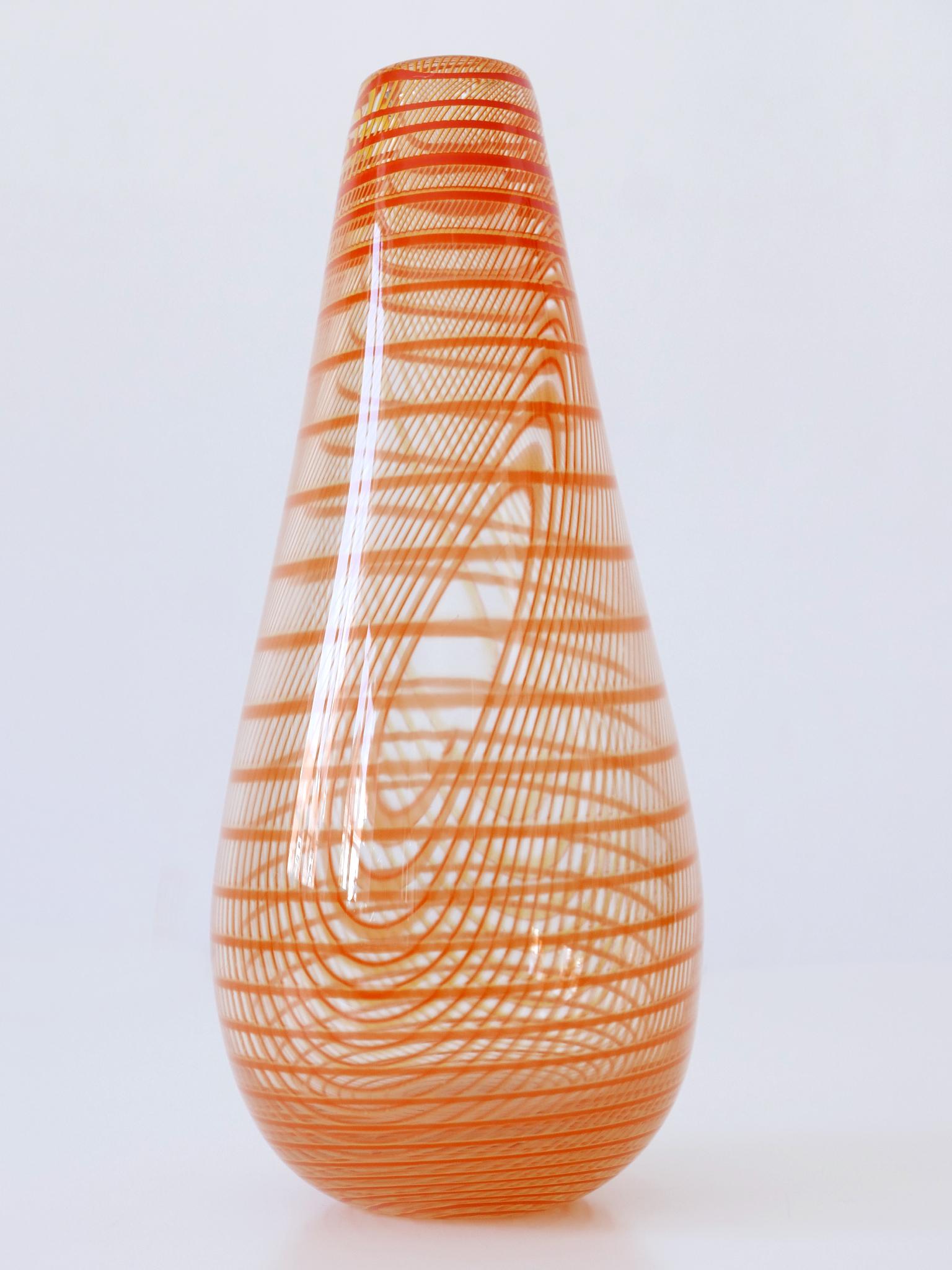 Tall, elegant and highly decorative art glass vase with stripes. Designed by Olle Brozén for Kosta Boda Sweden, 1980s. Signed at the bottom: Olle Brozén. 7341012. Kosta Boda. Lim. Ed. 100

Executed in thick art glass with stripes.

Dimensions:
H