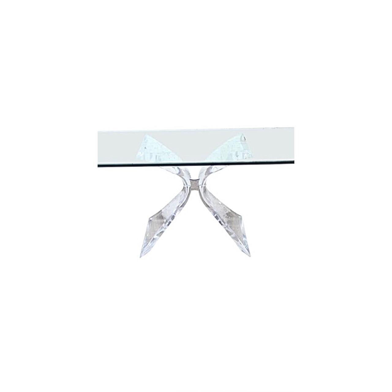 Glamourous “Butterfly” Lucite dining table with square glass top by Lion in Frost. Created of Lucite and resembling butterfly wings, this table is sculptural. The wings are connected thru a chrome-plated metal center. This piece is signed and a
