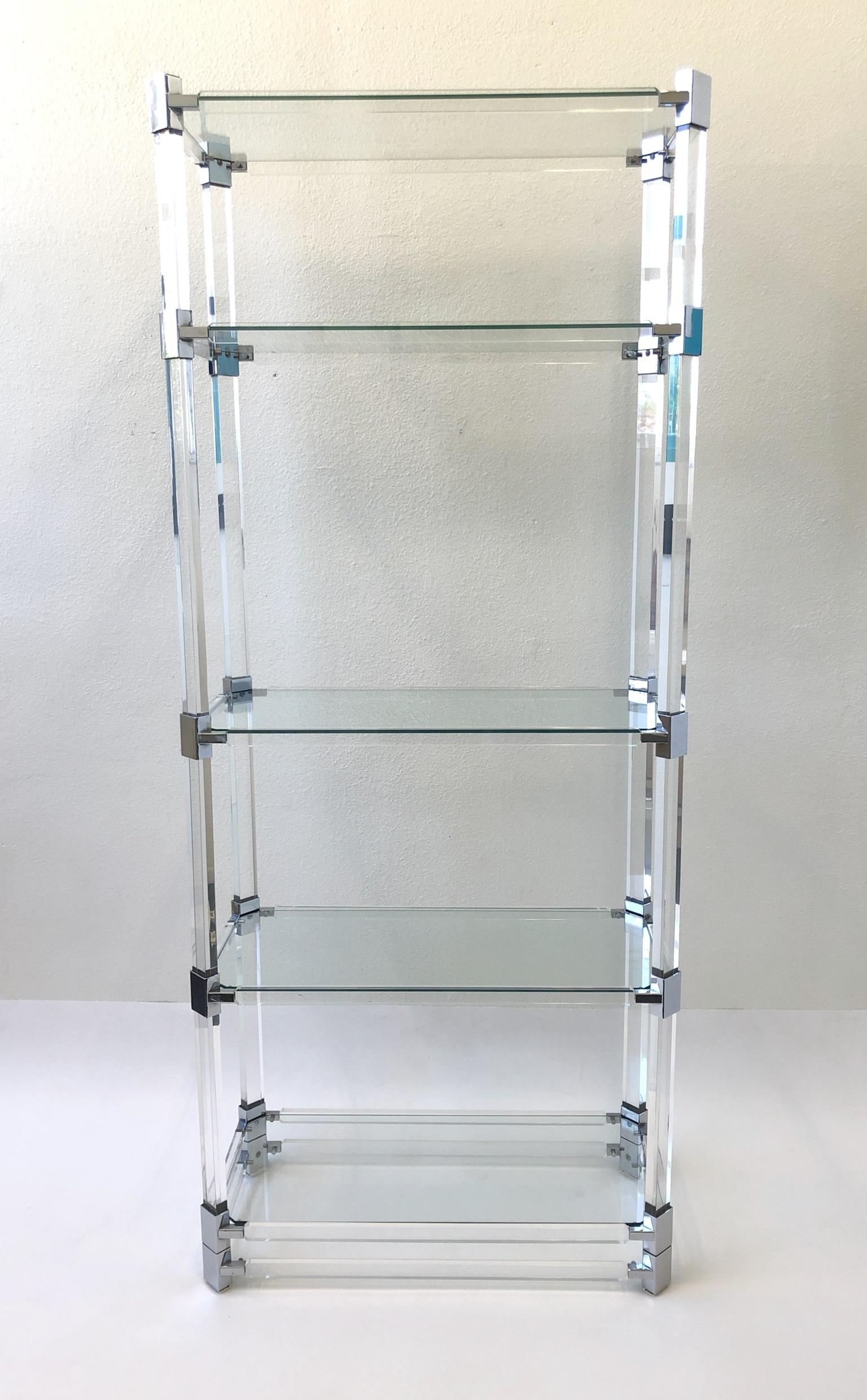 A glamorous clear acrylic and polish chrome with glass shelves étagère design in 1973 by renowned American design Charles Hollis Jones for Paul Laszlo. The étagère is in original condition, so it shows minor wear. The étagère is signed and dated by