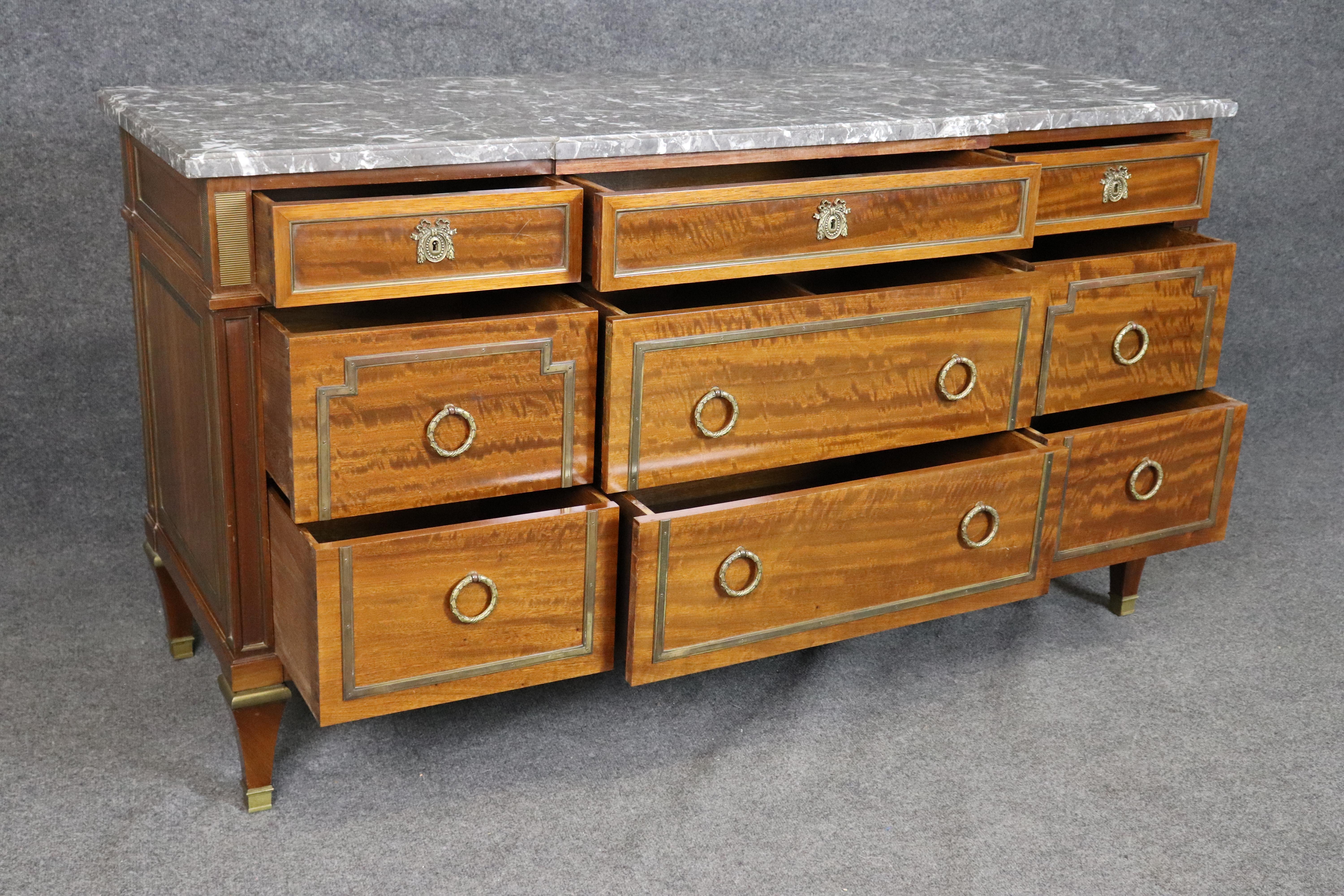 Make a statement with this exquisite Faded Ribbon Mahogany Sideboard, crowned with a luxurious Grey Griotte marble top and finished with refined bronze accents. Crafted with elegant proportions and classical symmetry, this piece features a rich