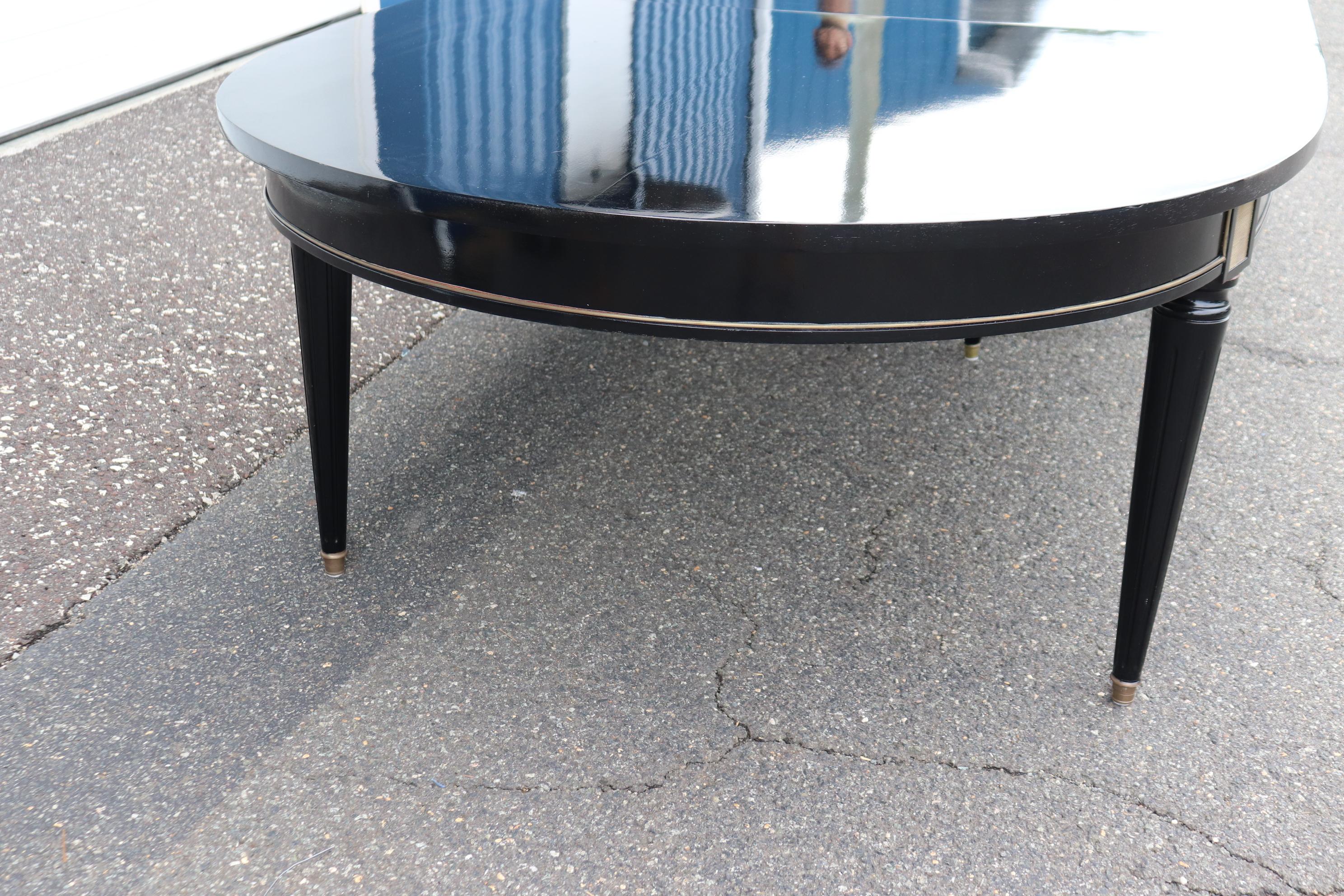 French Signed Maison Jansen Ebonized Black Lacquer Dining Table Brass Trim w 2 Leaves For Sale