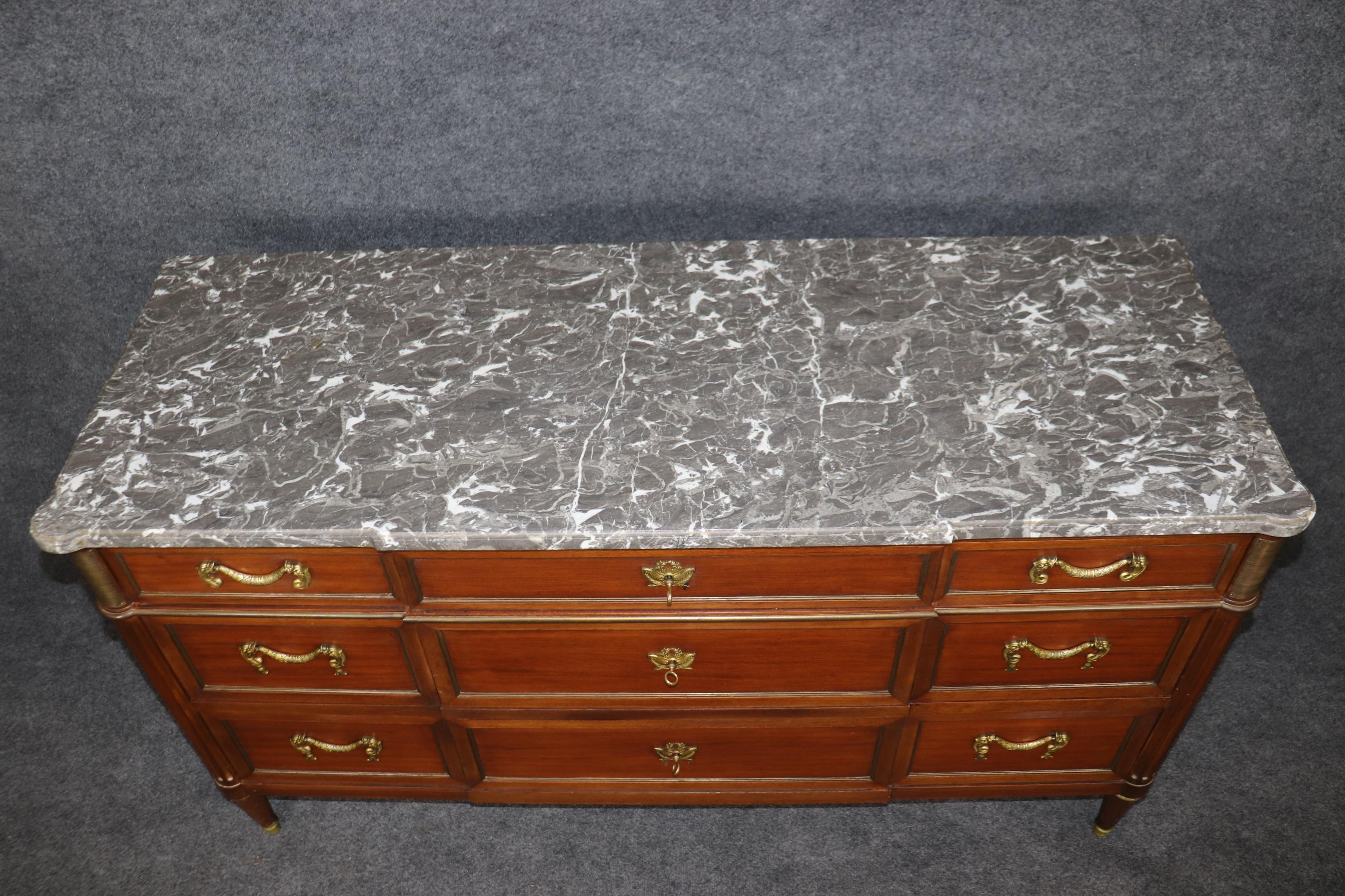 This is a gorgeous iconic Maison Jansen mahogany and marble top, bronze ormolu mounted dresser. The piece is signed and in good original condition with minimal signs of age and wear. Some minor fading from the sun over time on the sides. The dresser