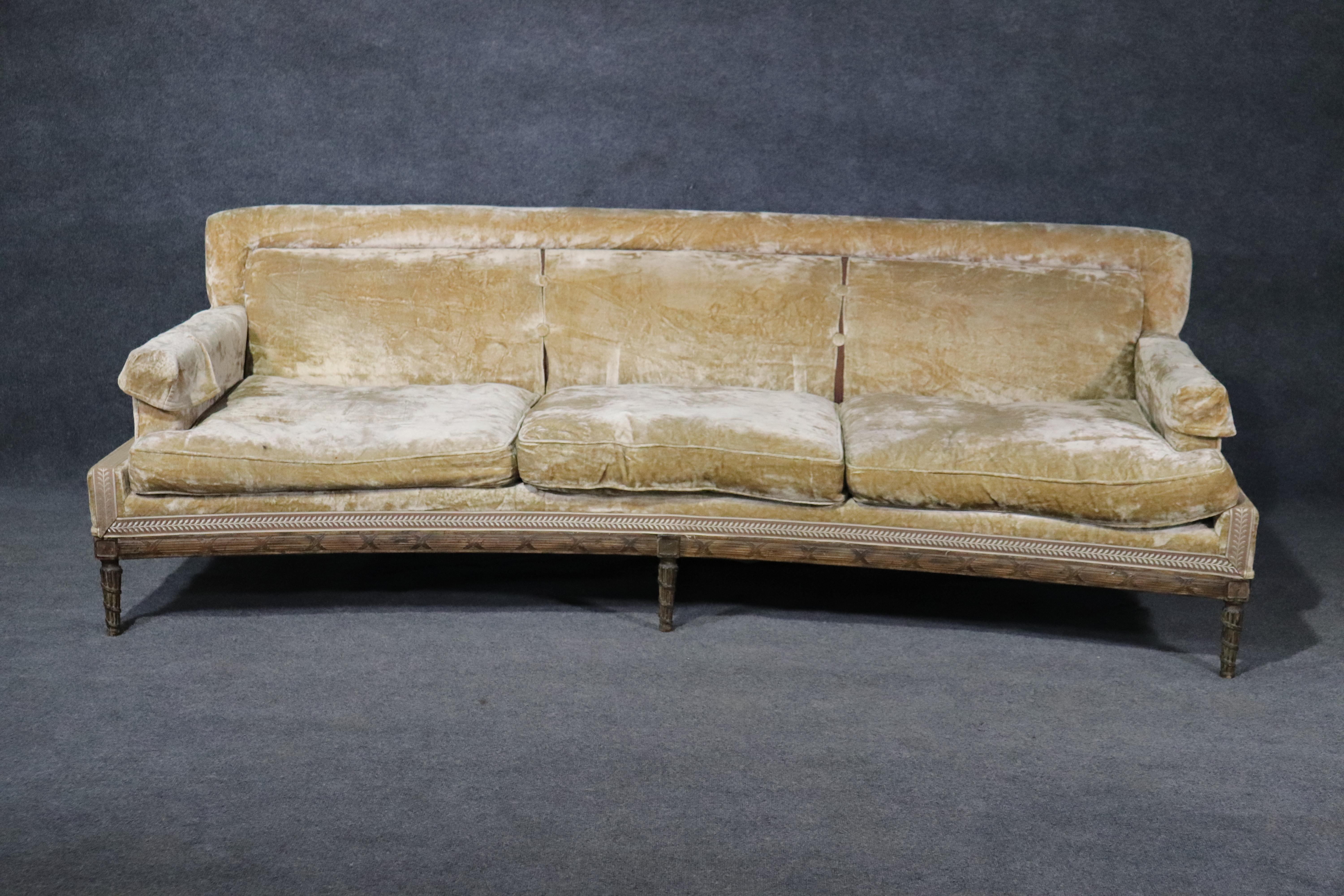This is a rare and extremely refined and sophisticated Louis XVI style sofa fitted with goose down filled pillows and a fantastic sand colored velvet or chenille upholstery. This sofa is in superb condition with no damage to the frame and the fabric