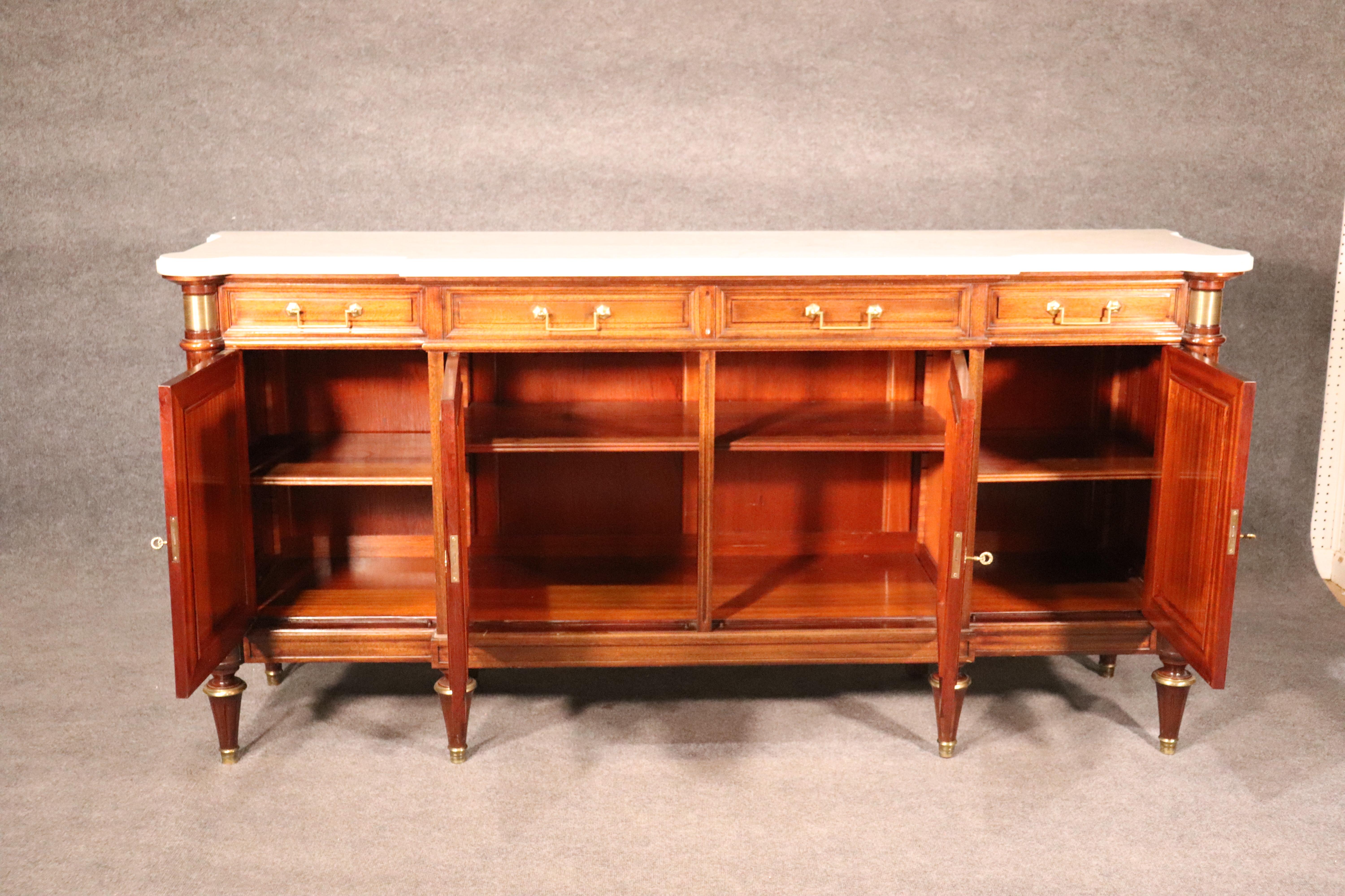 This Louis XVI or Directoire style sideboard features beautiful plum pudding mahogany and a gorgeous color. The color is a medium 