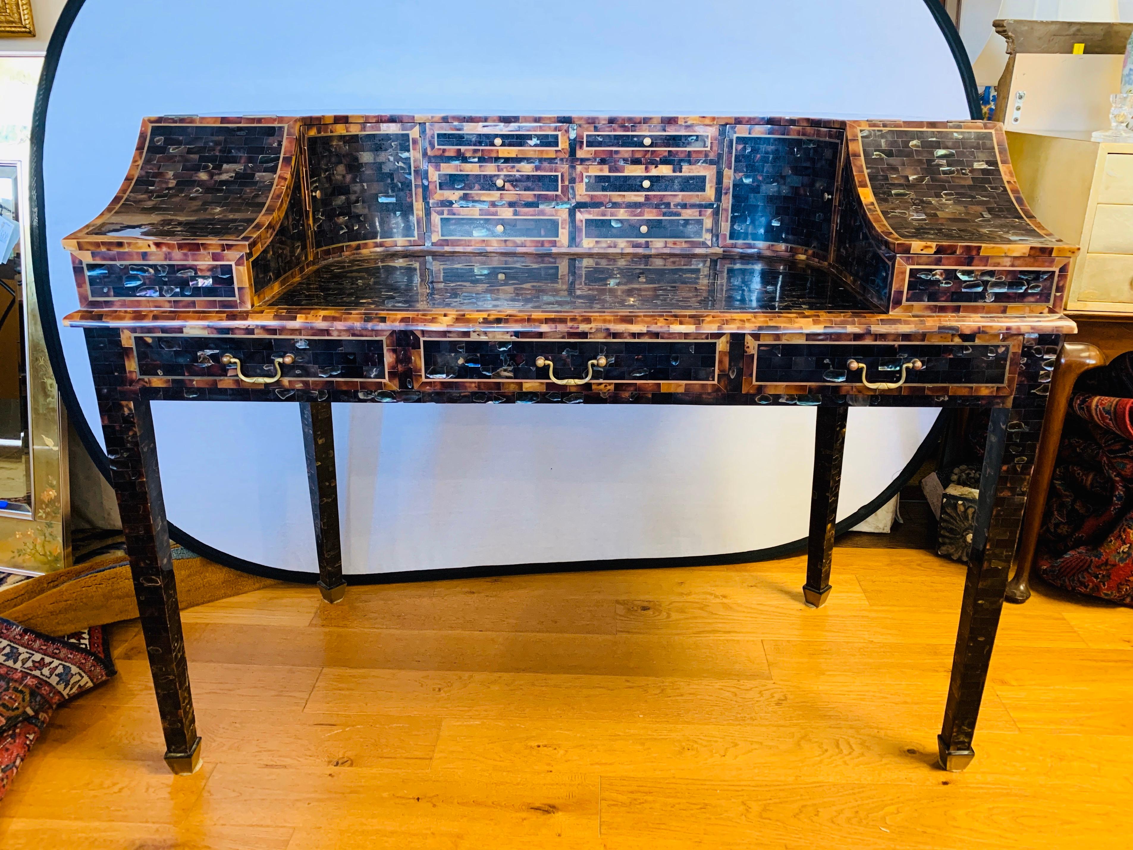 Stunning Regency style Carlton writing desk covered with tessellated horn in dark and light colors for contrast. It has a  horseshoe top section with an arrangement of drawers and cupboards and the lower section with three drawers. Made by
