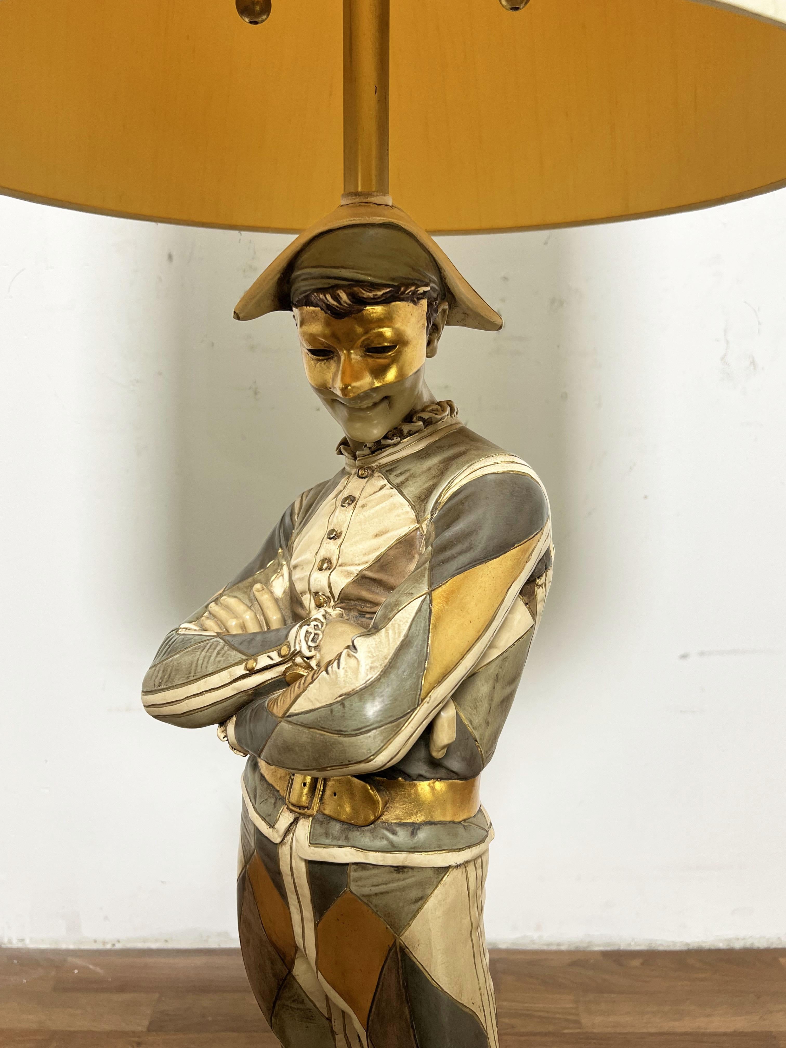 Signed Marbro Lamp Company harlequin or jester lamp, circa 1960s. The design is based on an 1879 bronze sculpture (note inscription on the base).   This is the larger version of this lamp.  Comes with original diamond embossed linen shade. 

Note,