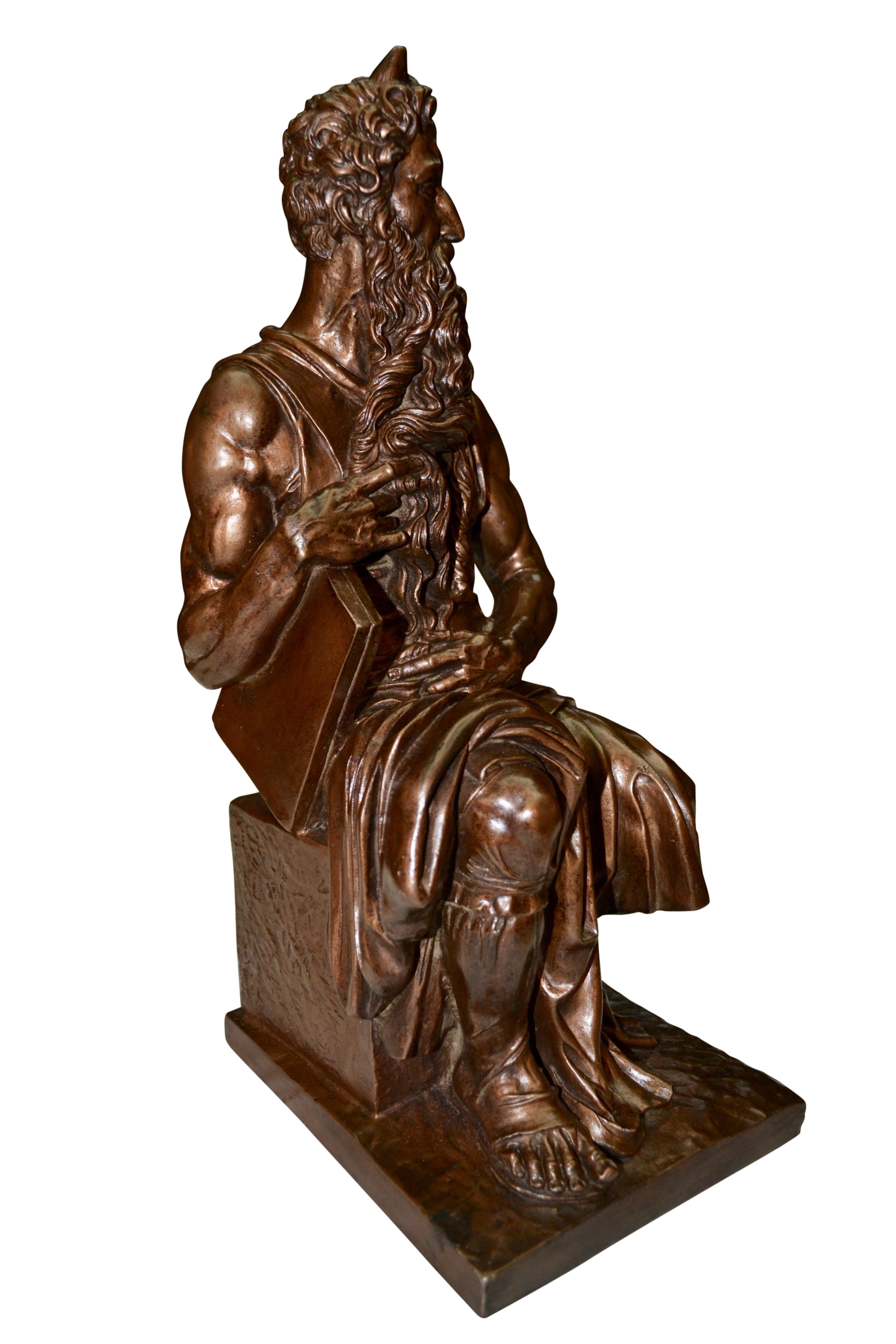 An exceptionally well executed bronzed terracotta copy of seated Moses holding the Commandment tablet, a hugely famous sculpture by the Italian High Renaissance artist Michelangelo. The marble original is housed in the church of San Pietro in
