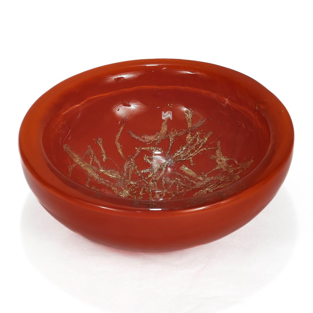 A fine mid-century modern Murano glass bowl.

By Venini.

Designed by Toni Zuccheri.

In the form of a thick glass bowl with complex copper inclusions on opaque orange ground.

Designed in 1964.

Marked to the base with an etched signature 'Venini
